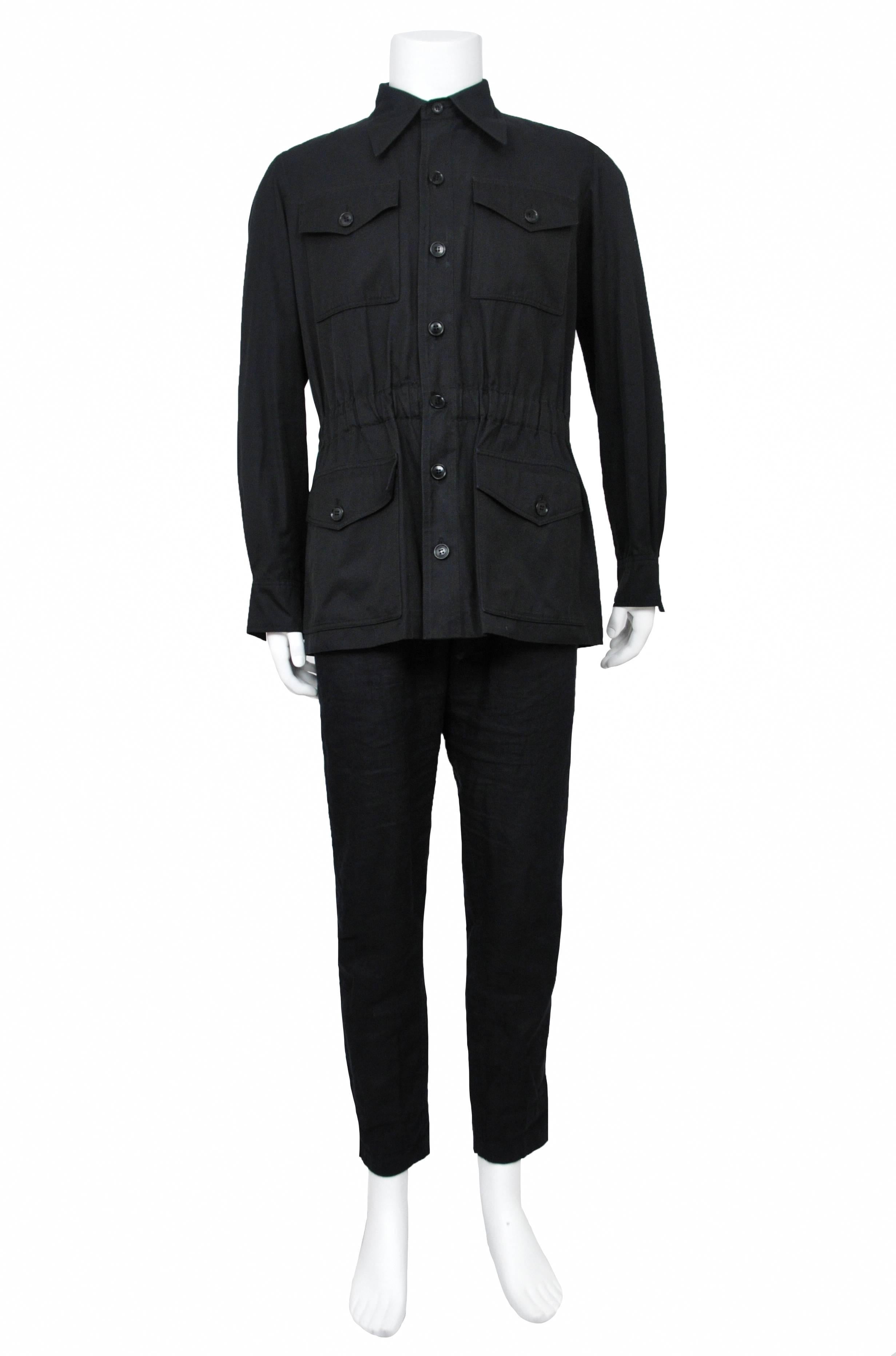 Vintage Yves Saint Laurent mens black iconic collared safari jacket featuring button front pockets at the chest and hips and elastic at the waist.
Please inquire for additional images.