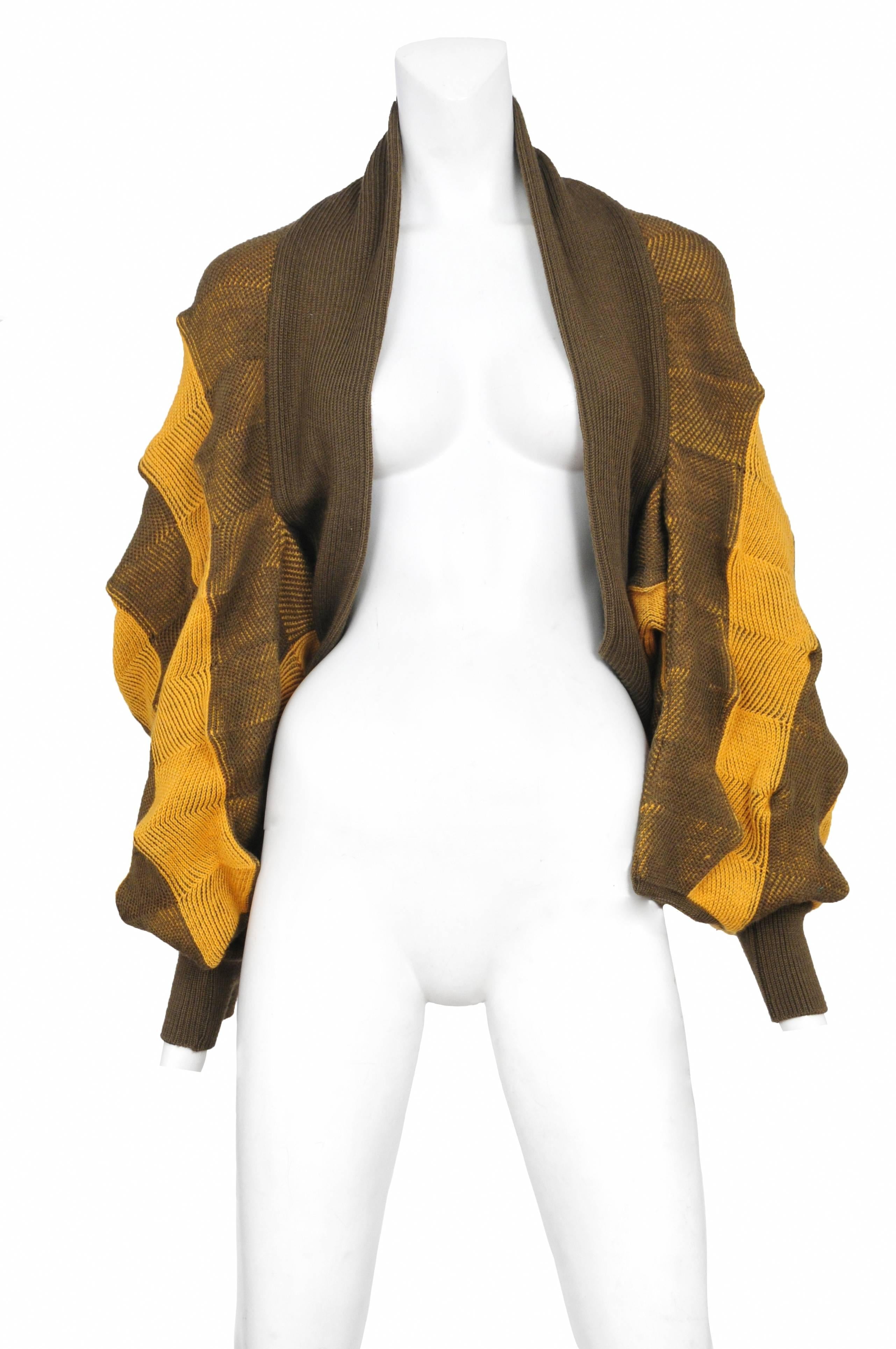 Vintage Issey Miyake wool shrug featuring an all over yellow and olive stripe 3D chevron textile design.
Please inquire for additional images.