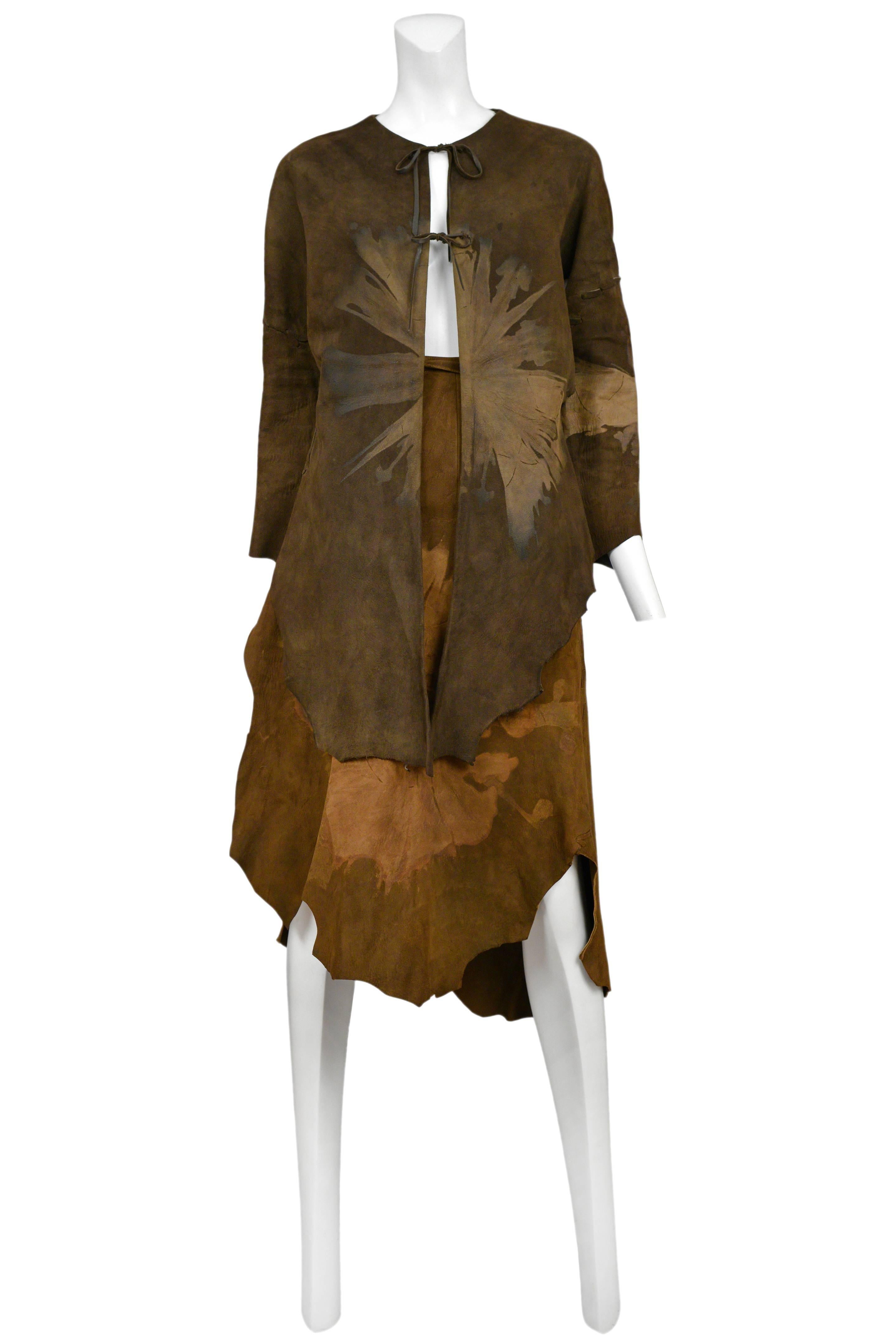Vintage Giorgio Sant Angelo brown suede two piece ensemble featuring a jacket held together by two strings and a matching wrap skirt, both stamped with large fossil style prints.
Please inquire for additional images.