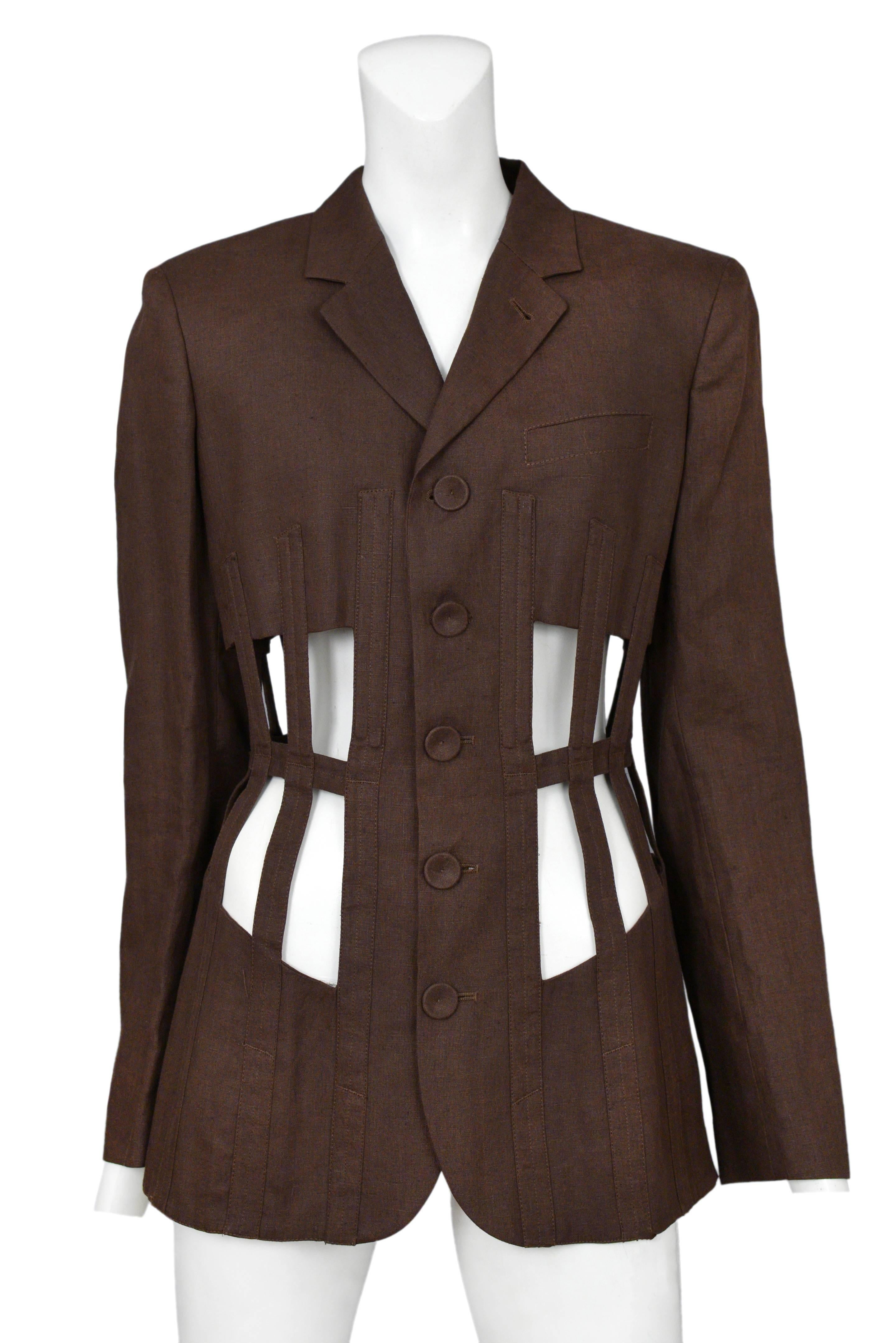 Vintage Jean Paul Gaultier iconic brown cage jacket featuring covered buttons up the front, lingerie style lace up corset closure at the back and exposed faux boning at the waist. Circa Autumn / Winter 1989.
Please inquire for additional images.