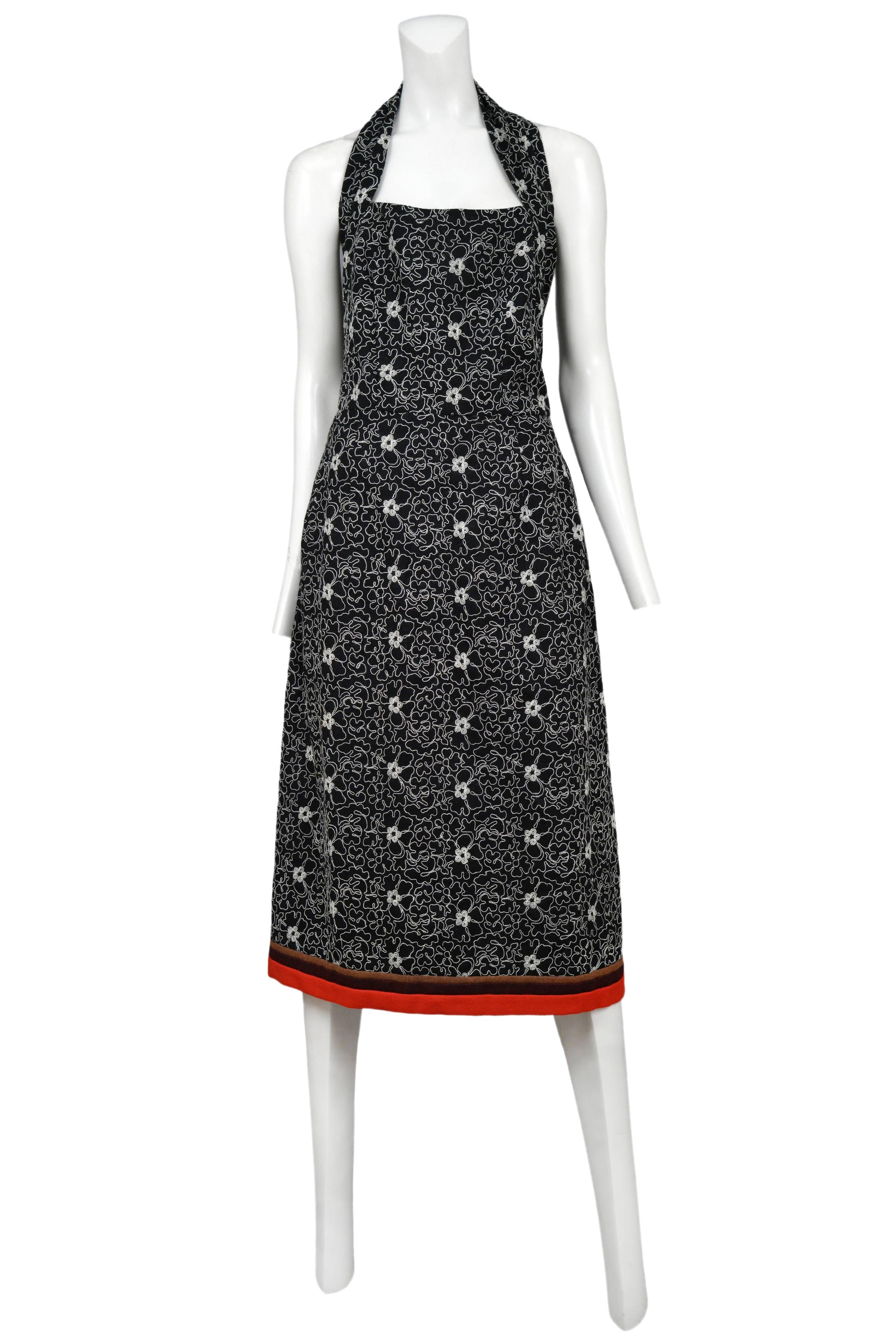 Vintage Comme des Garcons black halter dress featuring all over white floral embroidery and multi-color red, burgundy, and rust brown felted trim at hem. From the Autumn / Winter 1999 Collection.

Excellent Vintage Condition.

Please inquire for