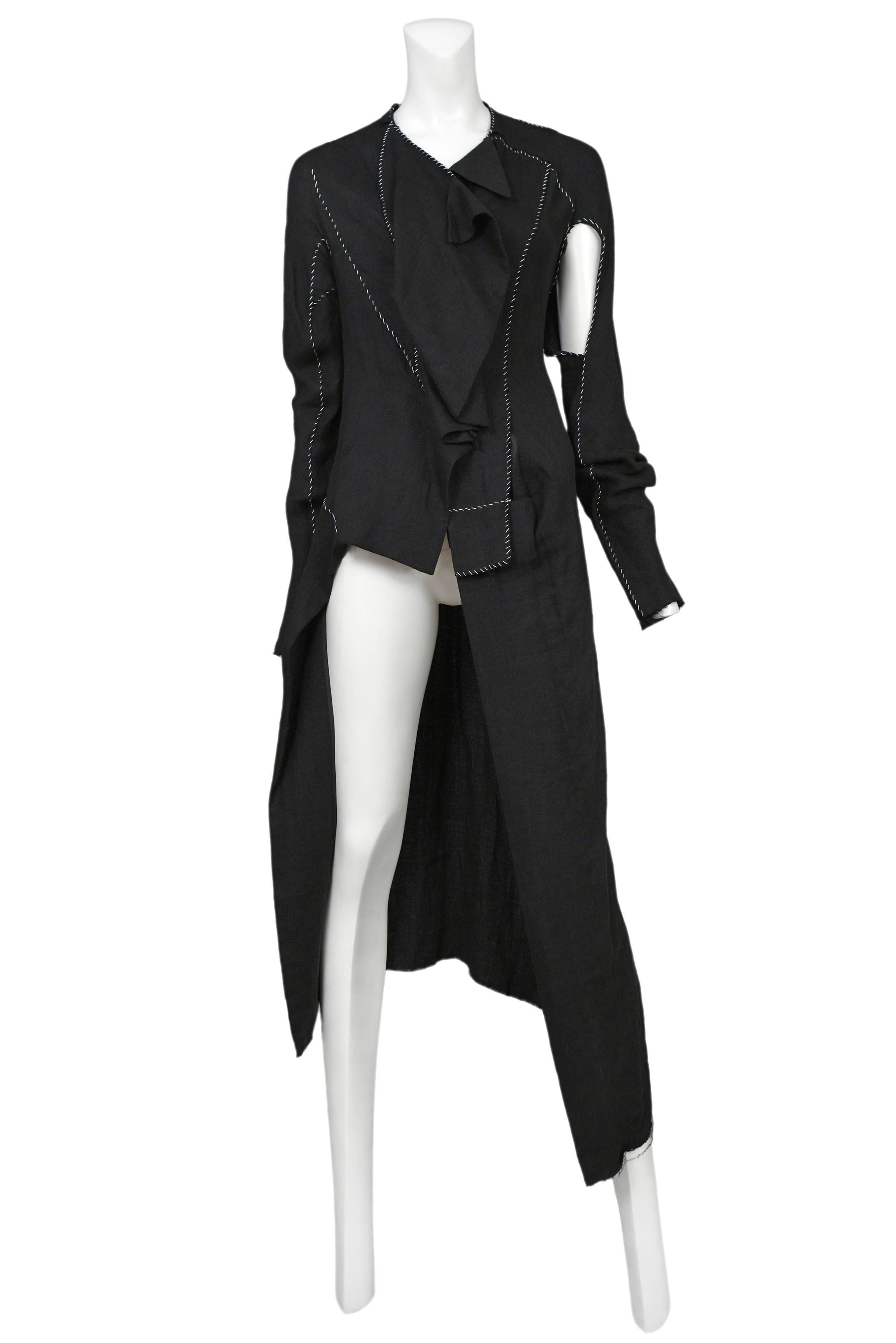 Vintage Yohji Yamamoto black coat featuring abstract cutouts and white raw stitch work throughout.
Please inquire for additional images.