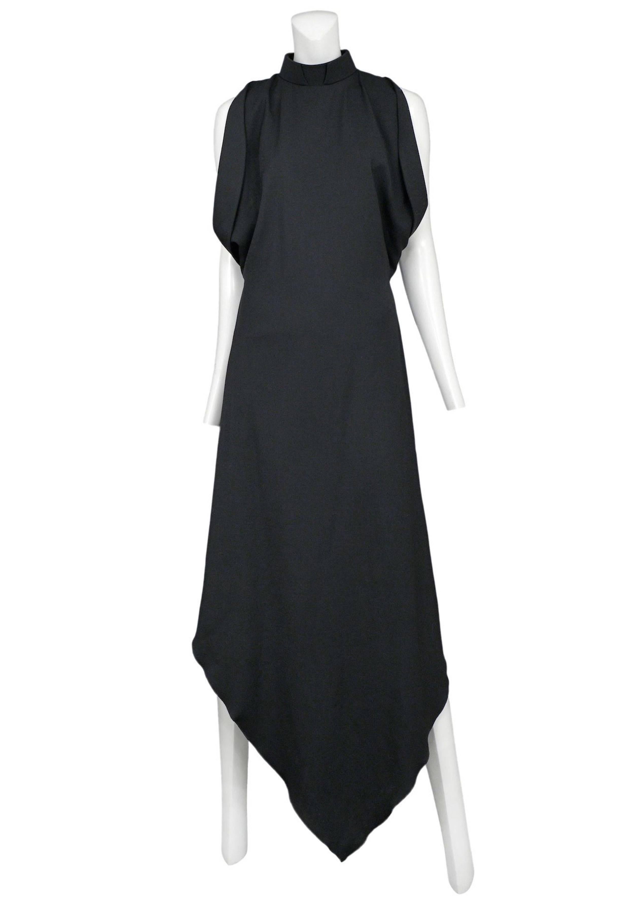 Vintage Maison Martin Margiela black long priestess gown featuring draped arm holes and a stiff priest like collar. Circa Autumn / Winter 2008.