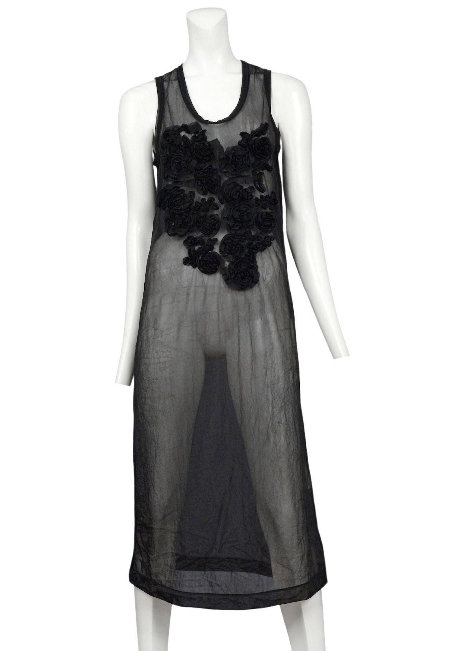 Vintage Comme des Garcons black sheer sleeveless below the knee dress featuring black ruffle appliqués adorning the chest. Circa 1994.

Please inquire for additional photos. 
