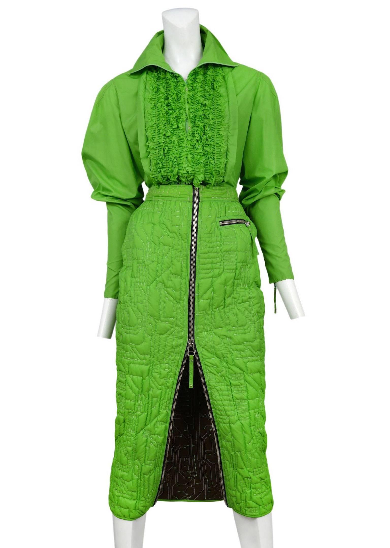 Vintage Jean Paul Gaultier neon green two piece ensemble featuring a zipper front high collard shirt with tuxedo rows of ruffles and zippers at the sleeves, and a matching zipper front mid length skirt with allover abstract circuit board trapunto