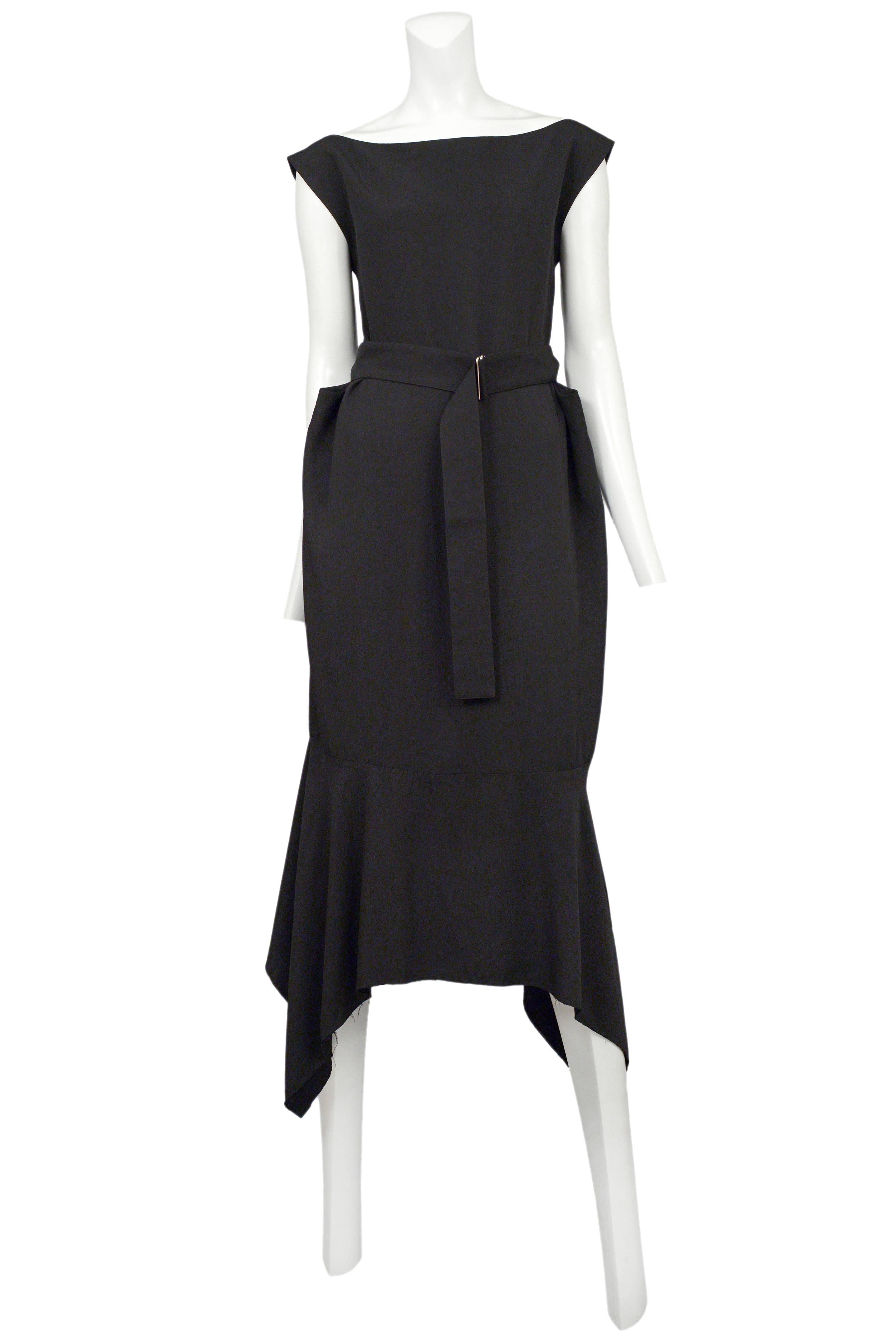 Vintage Yohji Yamamoto black below the knee dress featuring cap sleeves, a curved hem, a built in waist belt and an open back.
Please inquire for additional images.