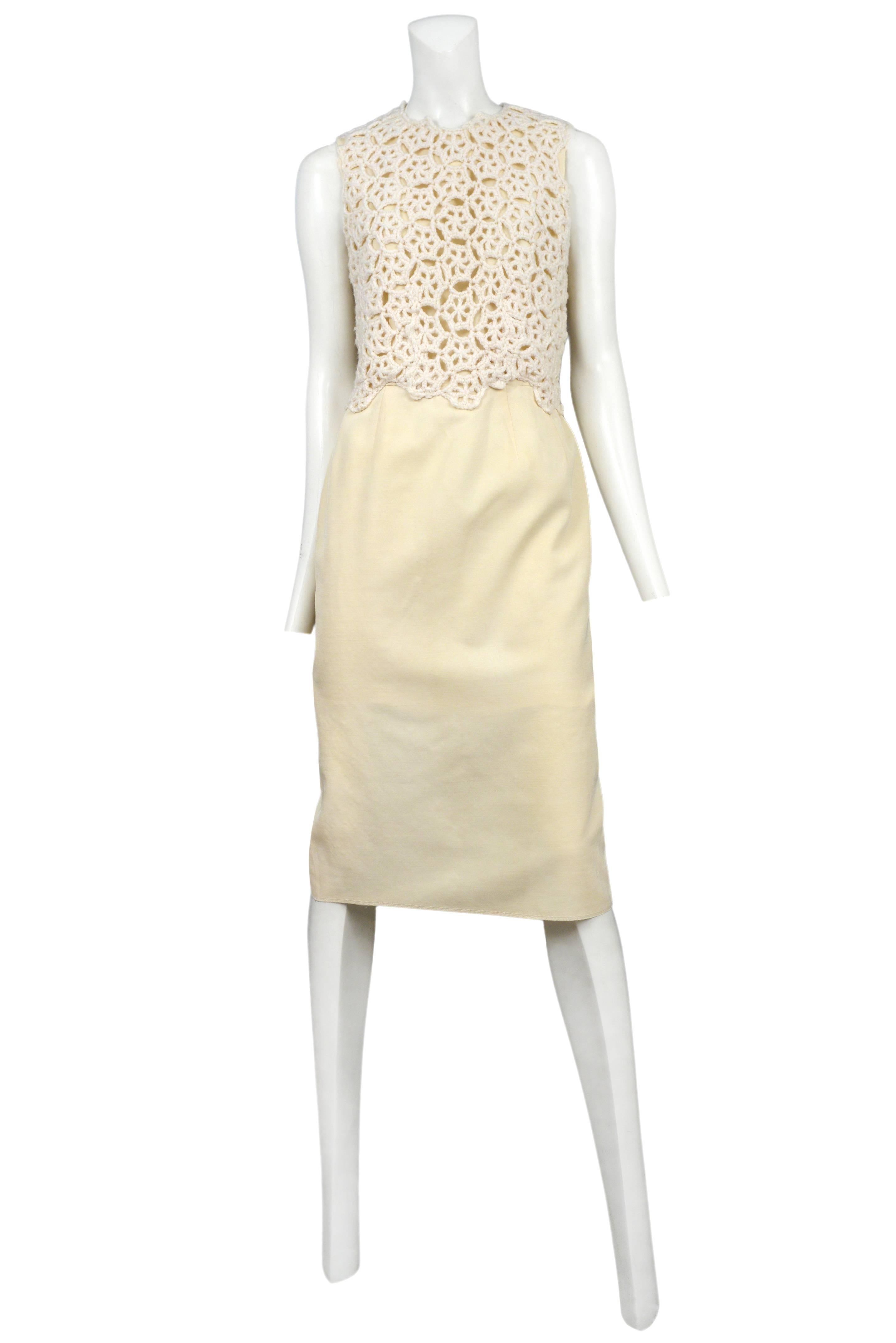 Vintage Comme des Garcons cream sleeveless below the knee pencil dress featuring cream crochet paneling above the waist. Circa 2011.
Please inquire for additional images.