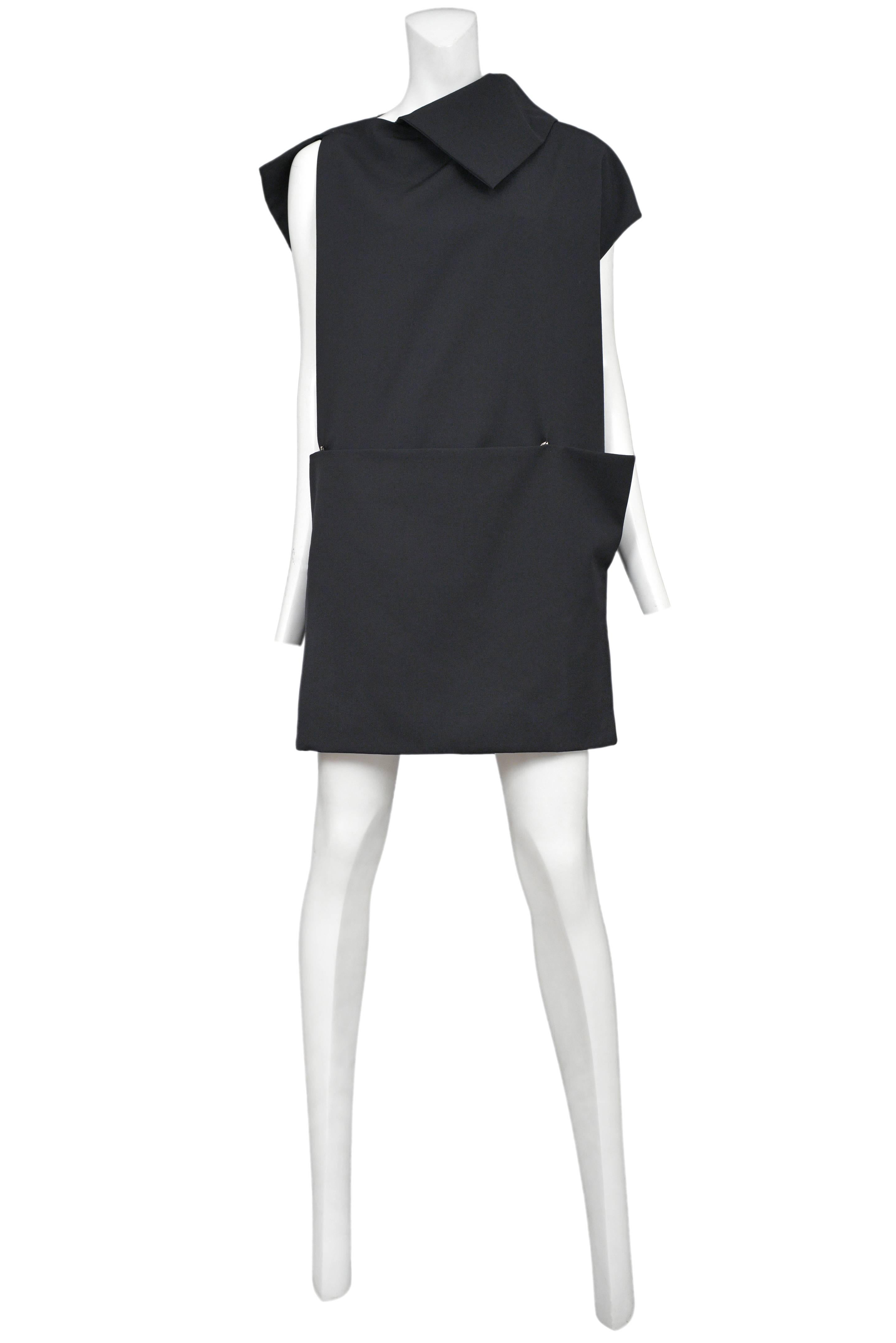 Vintage Yohji Yamamoto black origami style mini dress featuring an abstract folded collar and a skirt panel that folds and wraps across the waist and is kept in place with hook & eyes.
Please inquire for additional images.