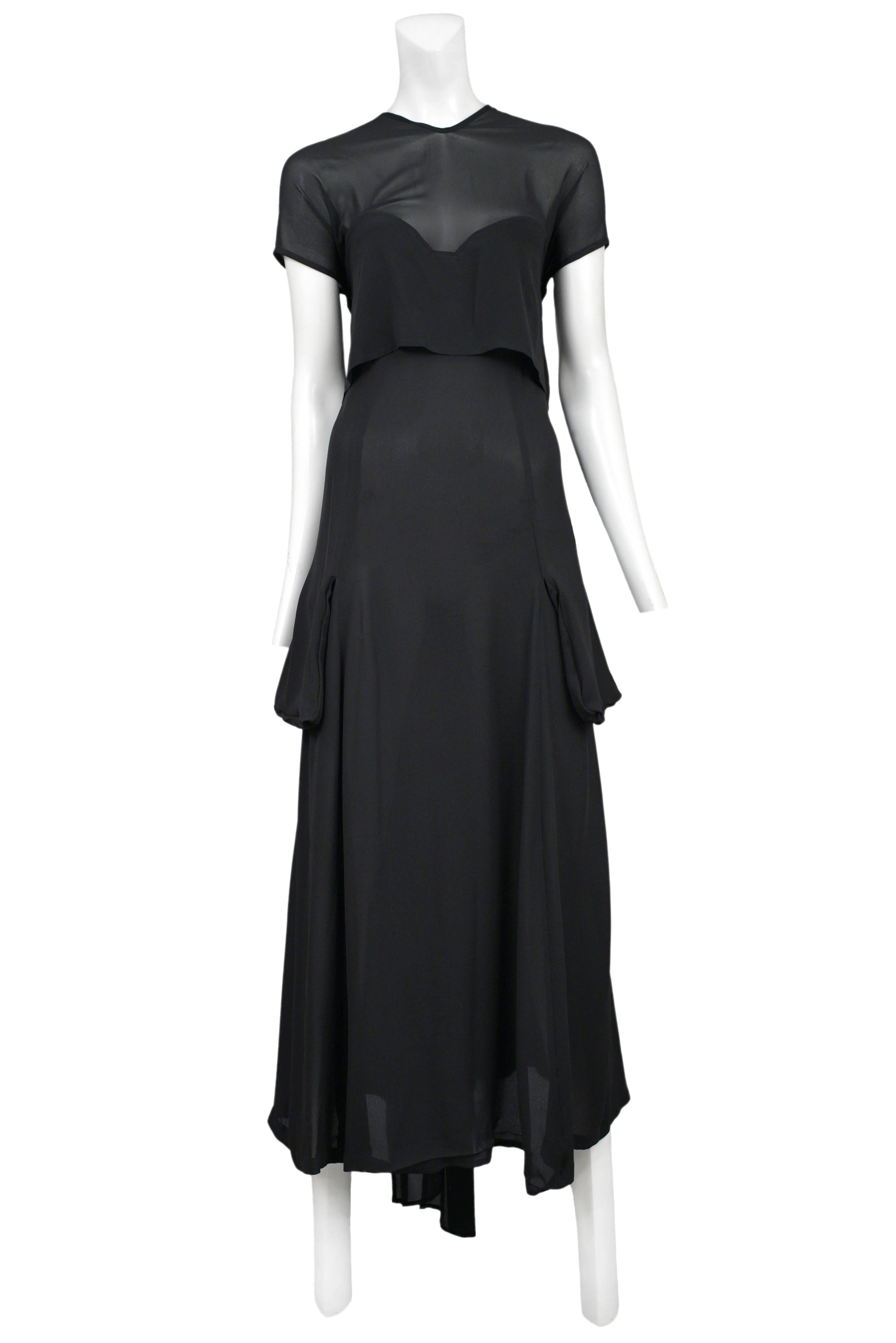 Vintage Yohji Yamamoto black chiffon gown featuring short sleeves, a v-neckline, additional inside layer to cover the curve of the bust, and a tie closure at the back.
Please inquire for additional images.