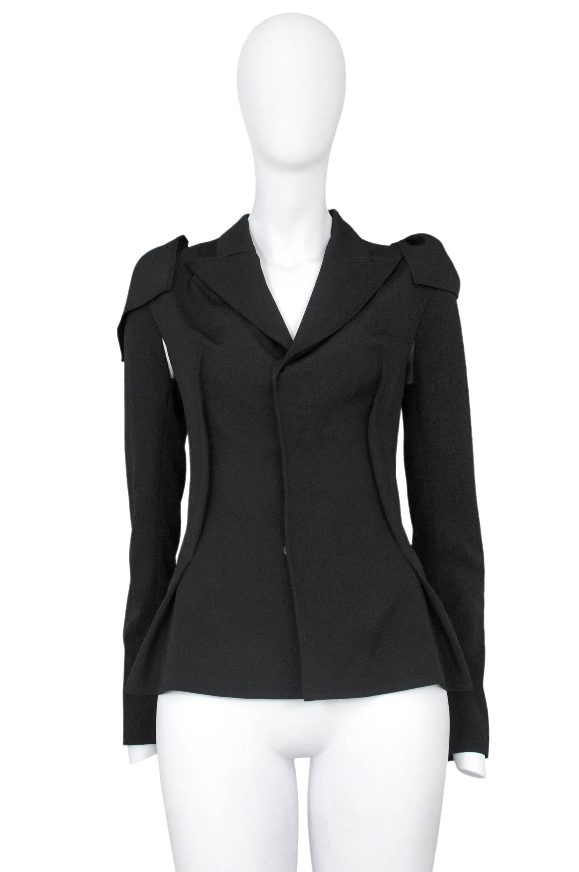 Vintage Yohji Yamamoto black blazer featuring two reversed darts at the front torso and two removable long sleeves that get pulled through a hole atop either shoulder to hold their place.
Please inquire for additional images.