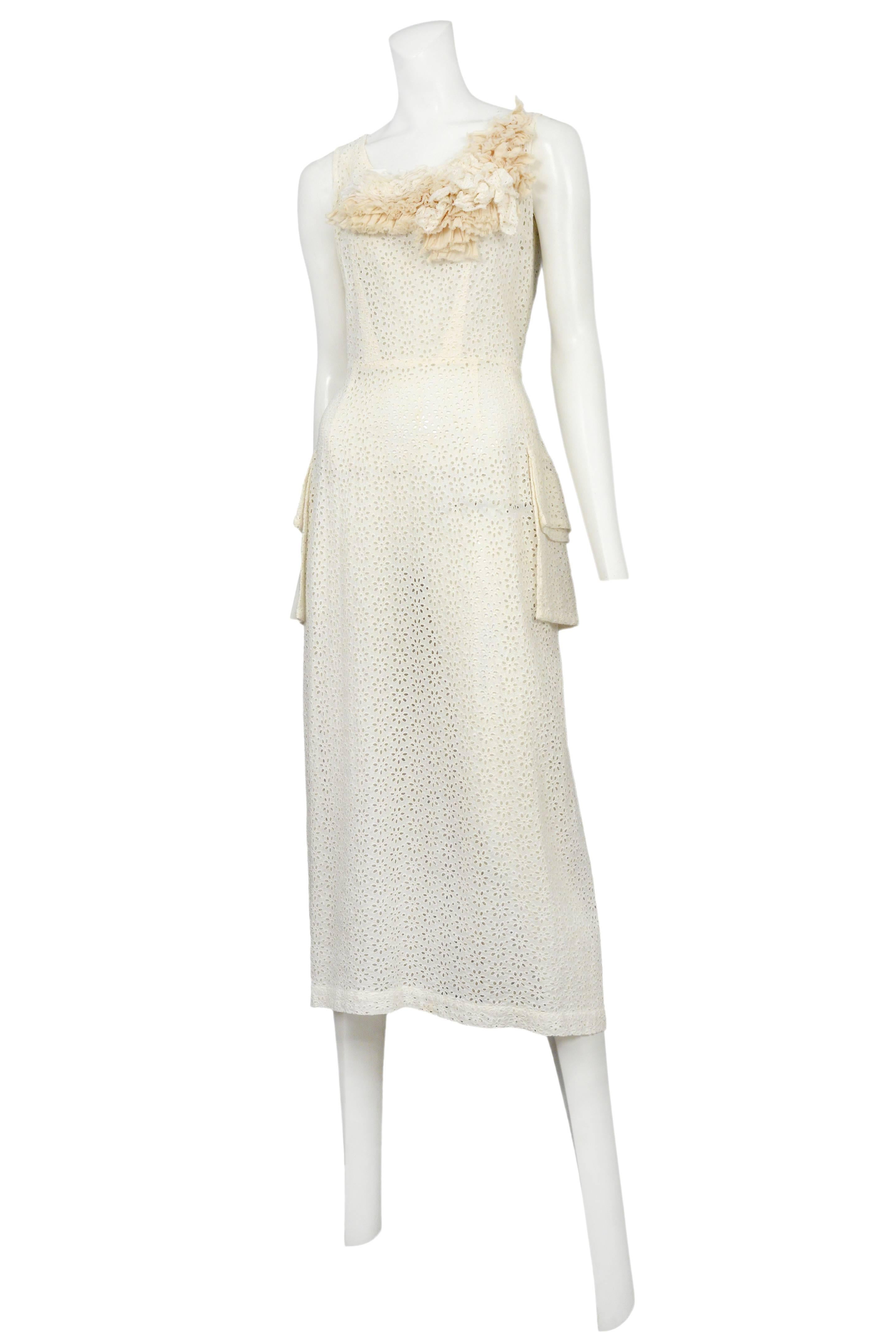 Vintage Comme des Garcons ivory eyelet lace below the knee, sleeveless dress featuring side pockets and gathered fabric adorning the neckline. Circa 1999.
Please inquire for additional images.