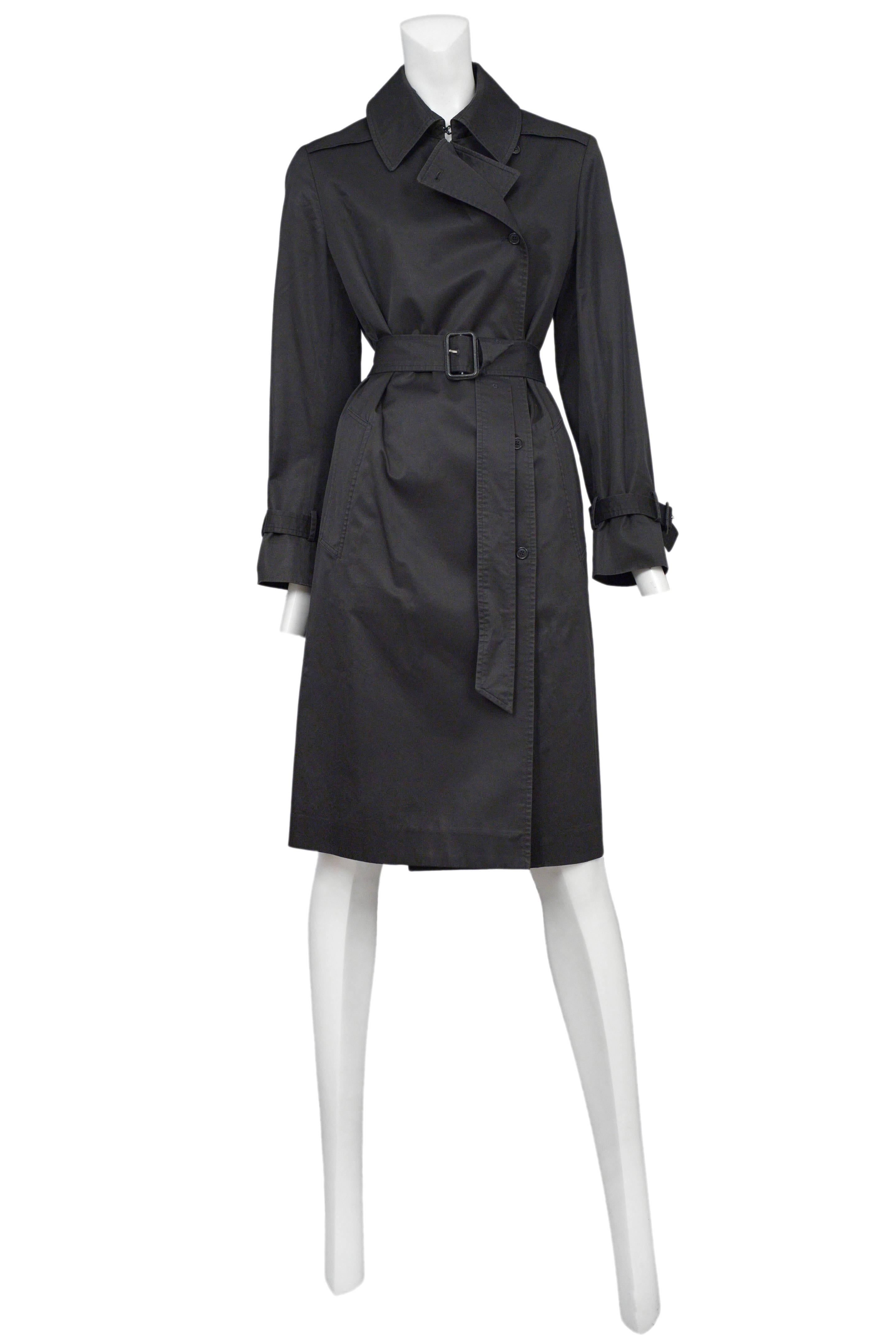 Vintage Maison Martin Margiela black trench coat featuring belted cuffs, side pockets and a matching buckled waist belt.
Please inquire for additional images.