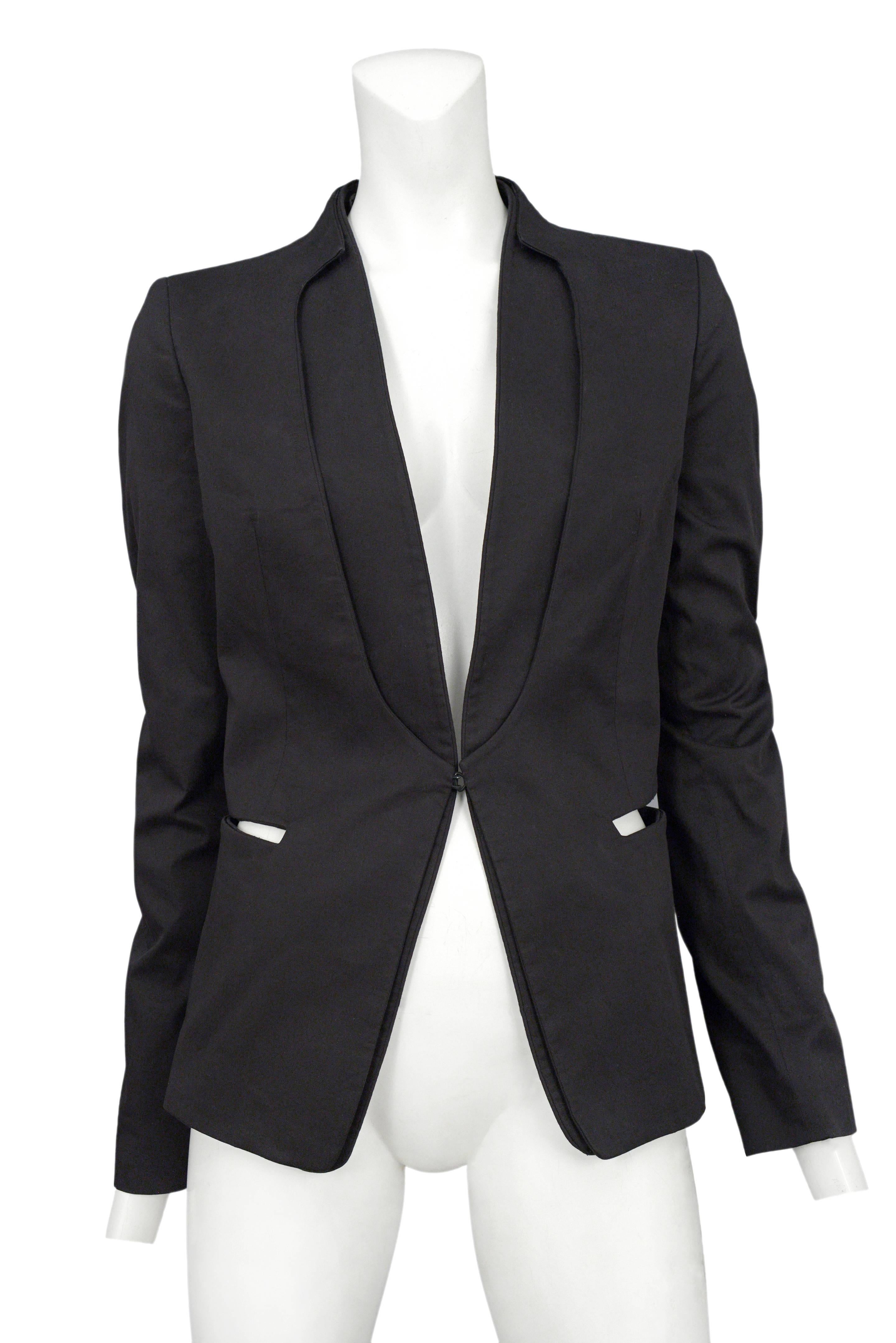 Vintage Maison Martin Margiela black blazer featuring a removable collar, hook and eye closure and cutout hip pockets.
Please inquire for additional images.