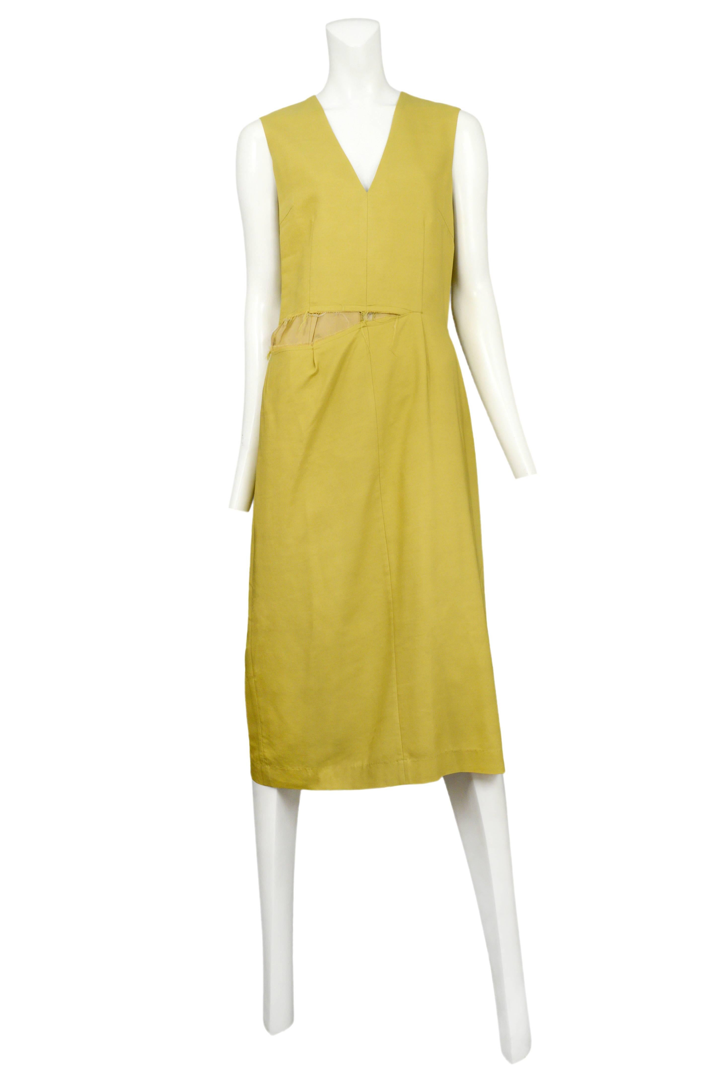Vintage Maison Martin Margiela mustard yellow sleeveless below the knee dress featuring an intentionally ripped seam at the waistline, a v-neckline and a back vent at the skirt. Circa Autumn / Winter 2003.
Please inquire for additional images.