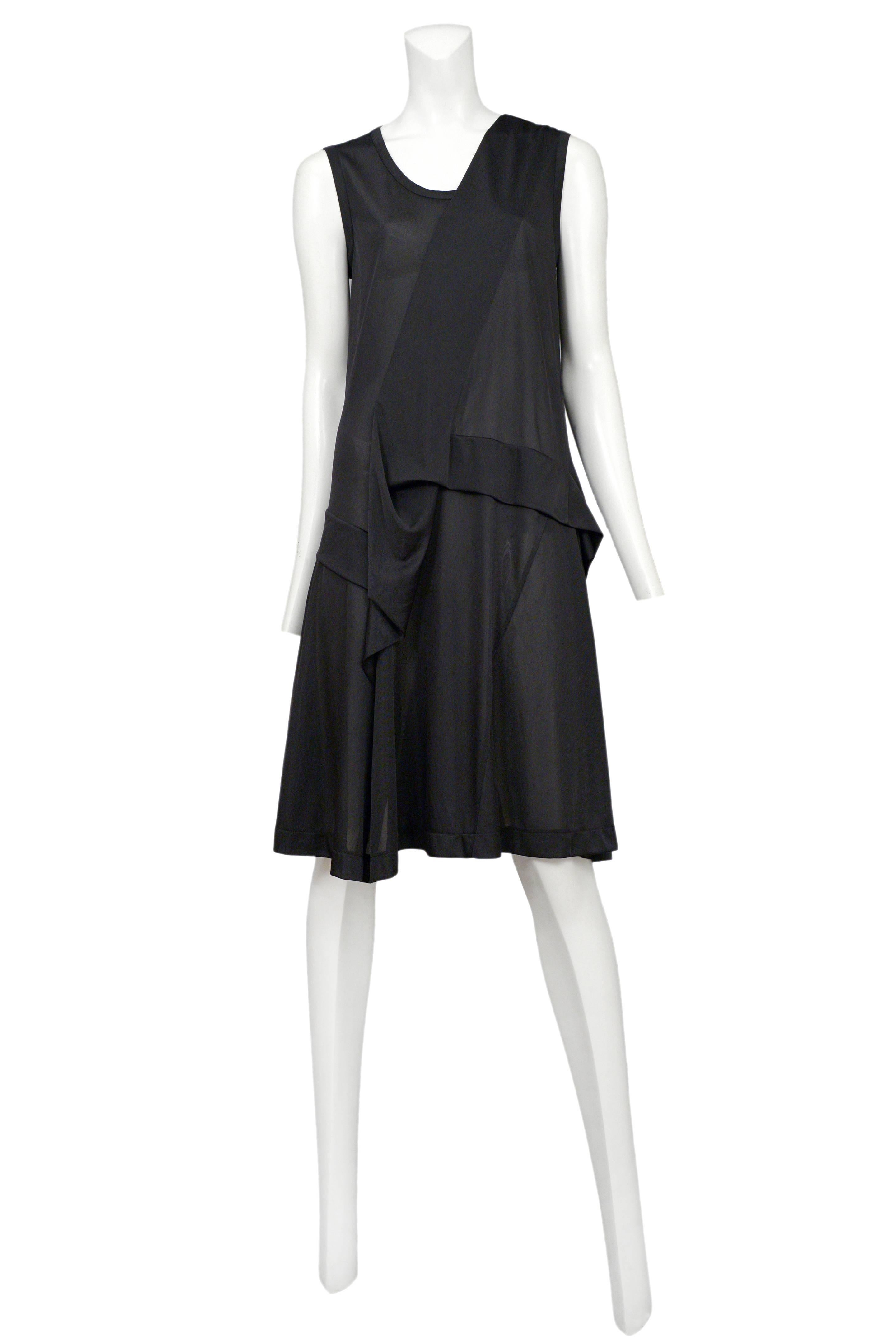 Vintage Junya Watanabe black sleeveless sheer tank dress featuring abstract draping across the center front and skirt. Circa Spring / Summer 1996.
Please inquire for additional images.