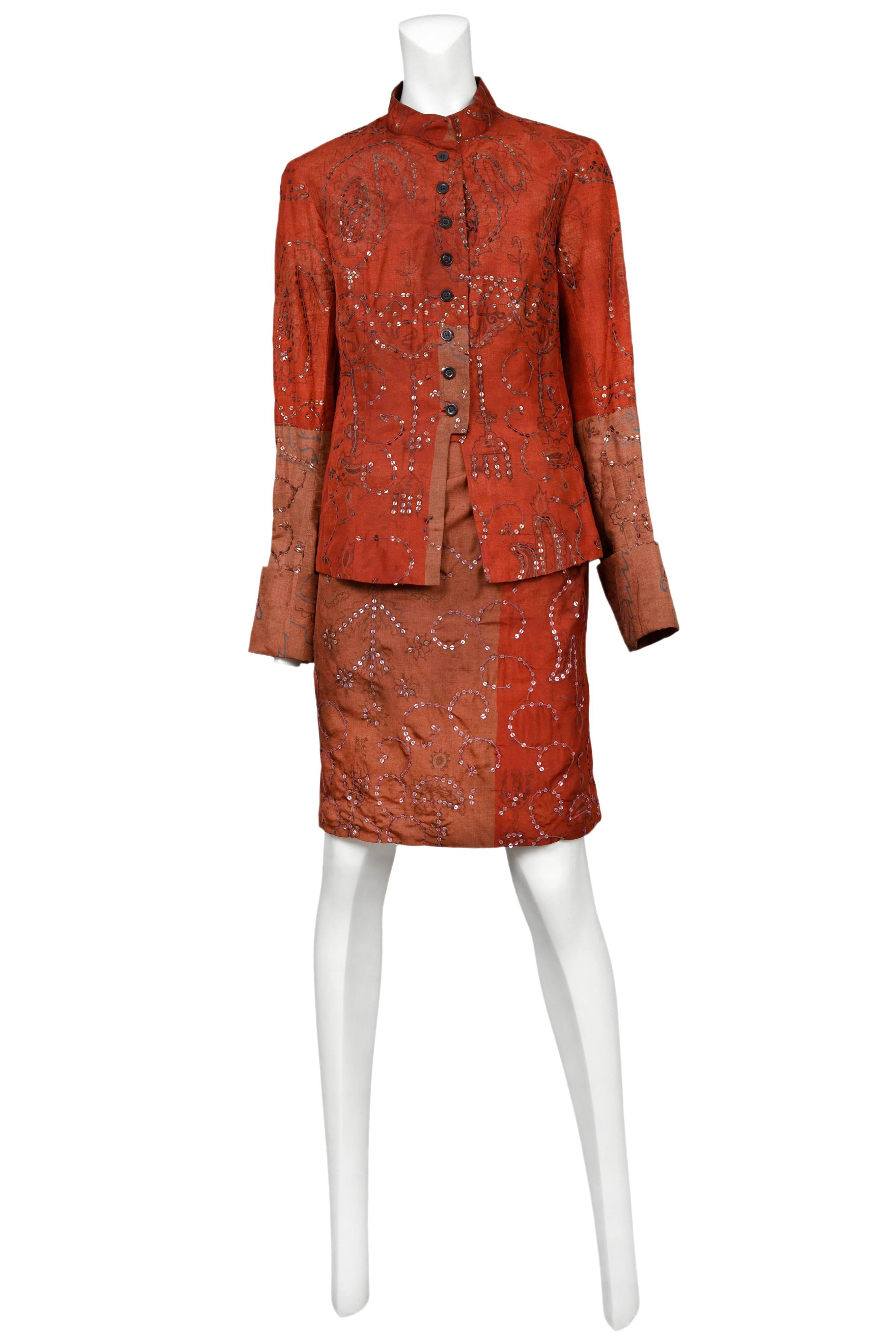 Vintage Dries Van Noten burgundy skirt suit featuring a button front entrance, duotone patchwork, a sari style knee length skirt and allover sequin embroidery.
Please inquire for additional images.