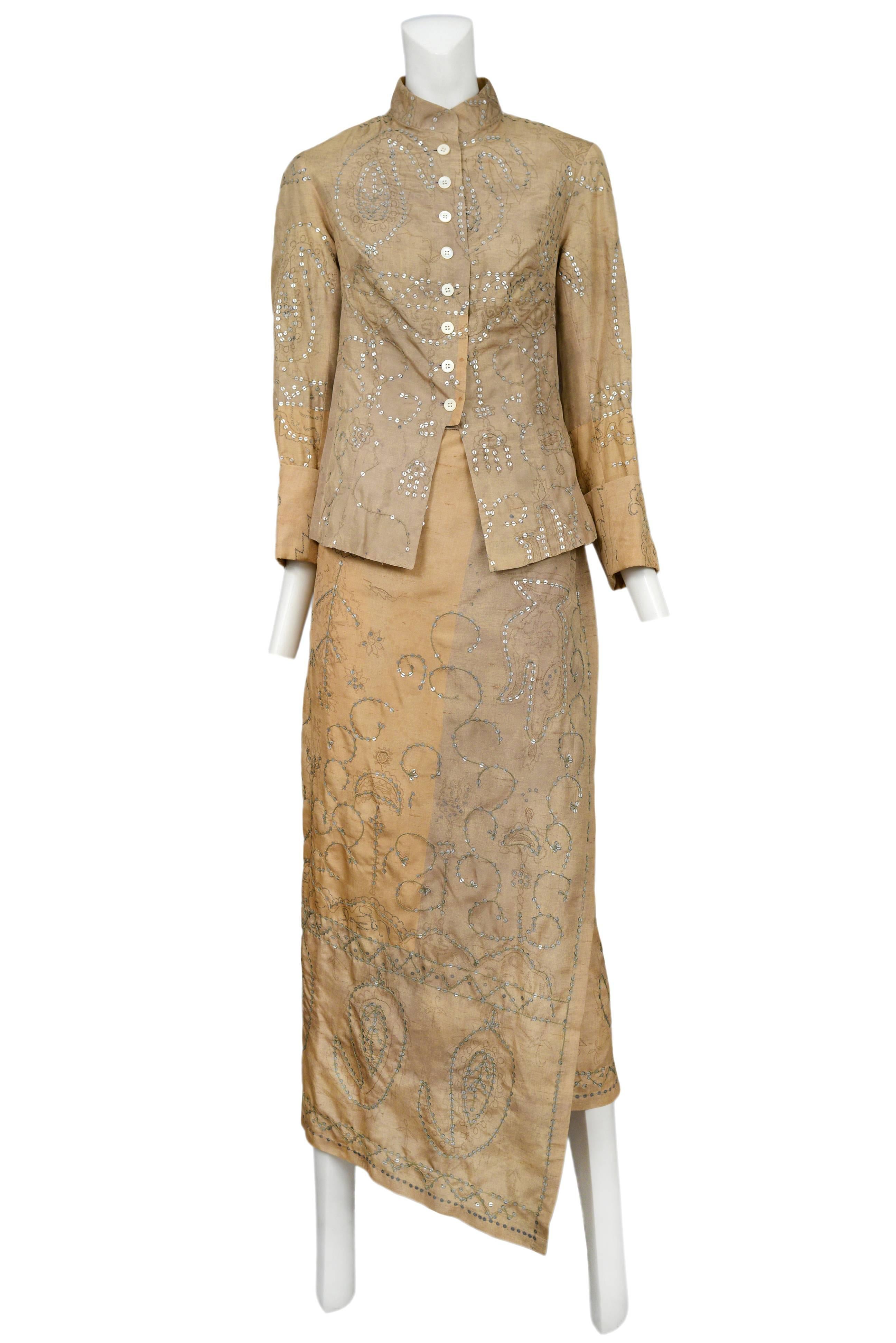 Vintage Dries Van Noten khaki skirt suit featuring a button front entrance, duotone patchwork, a sarong style wrap skirt and allover sequin embroidery.
Please inquire for additional images.