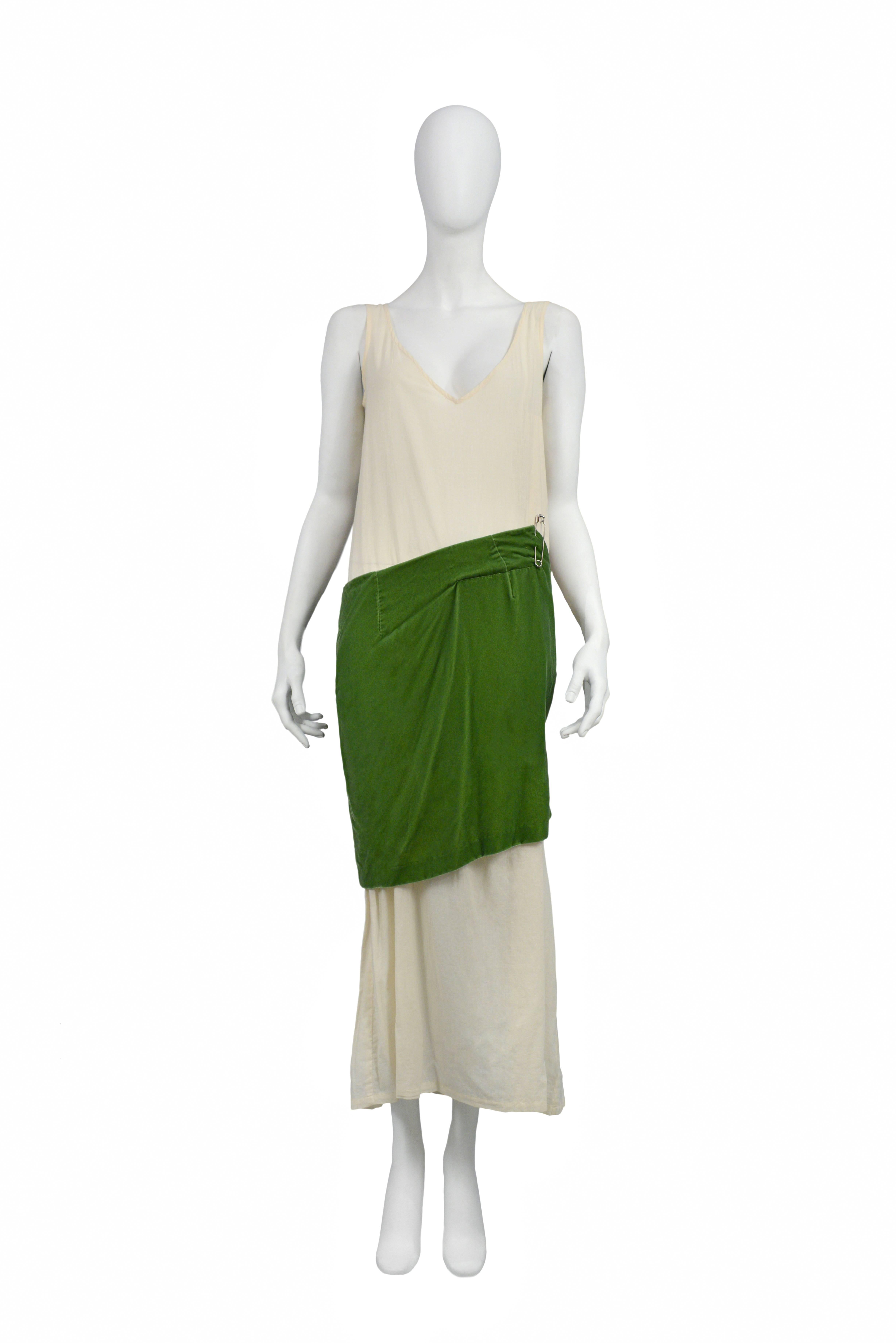 Iconic off white muslin and velvet gown. Bodice features dress makers off white muslin with v front and open seam at side. The skirt is made of green velvet and features an uneven hem. AW 1996.
Please inquire for additional images.