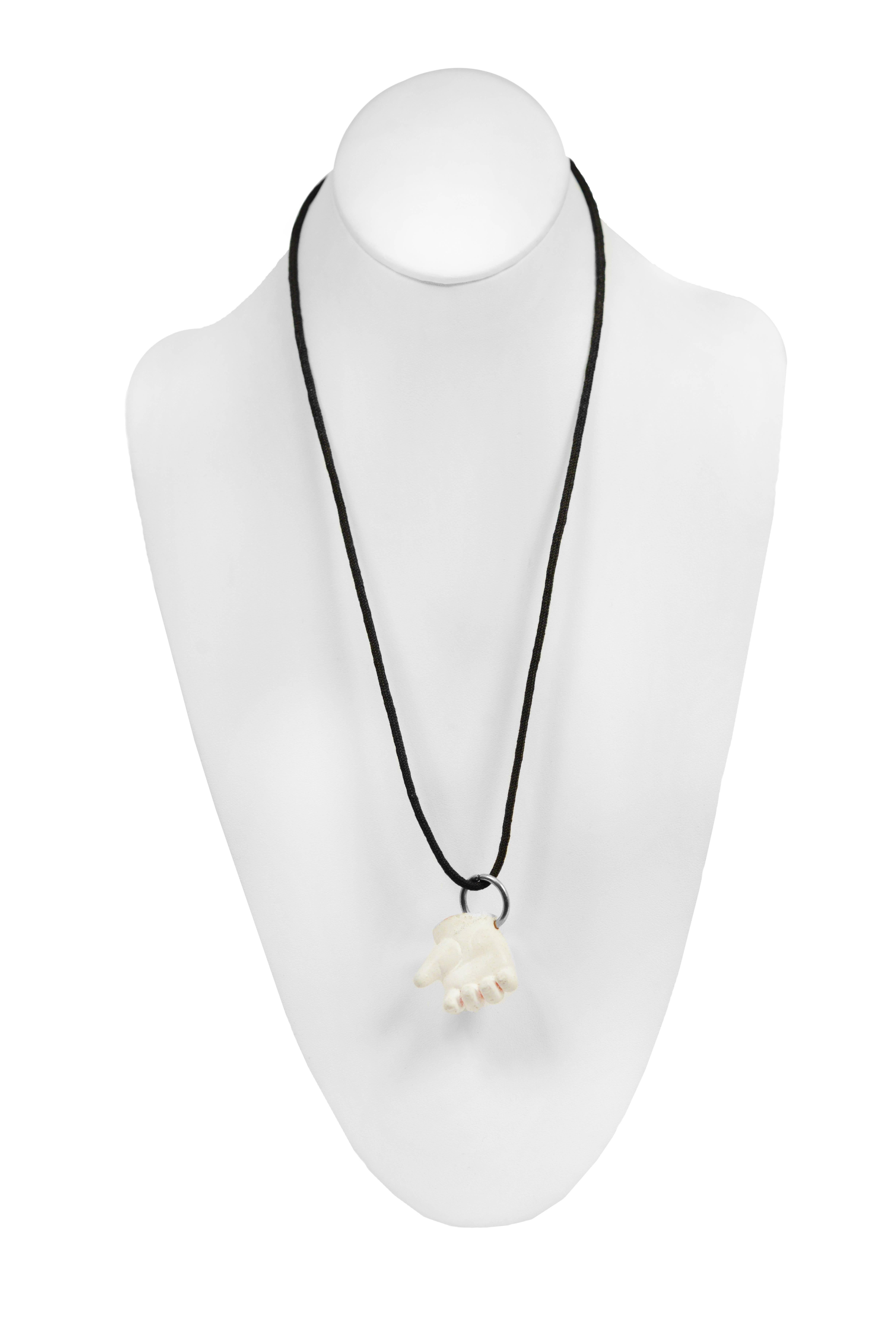 Vintage Maison Martin Margiela black necklace featuring a white doll hand pendant.
Please inquire for additional images.