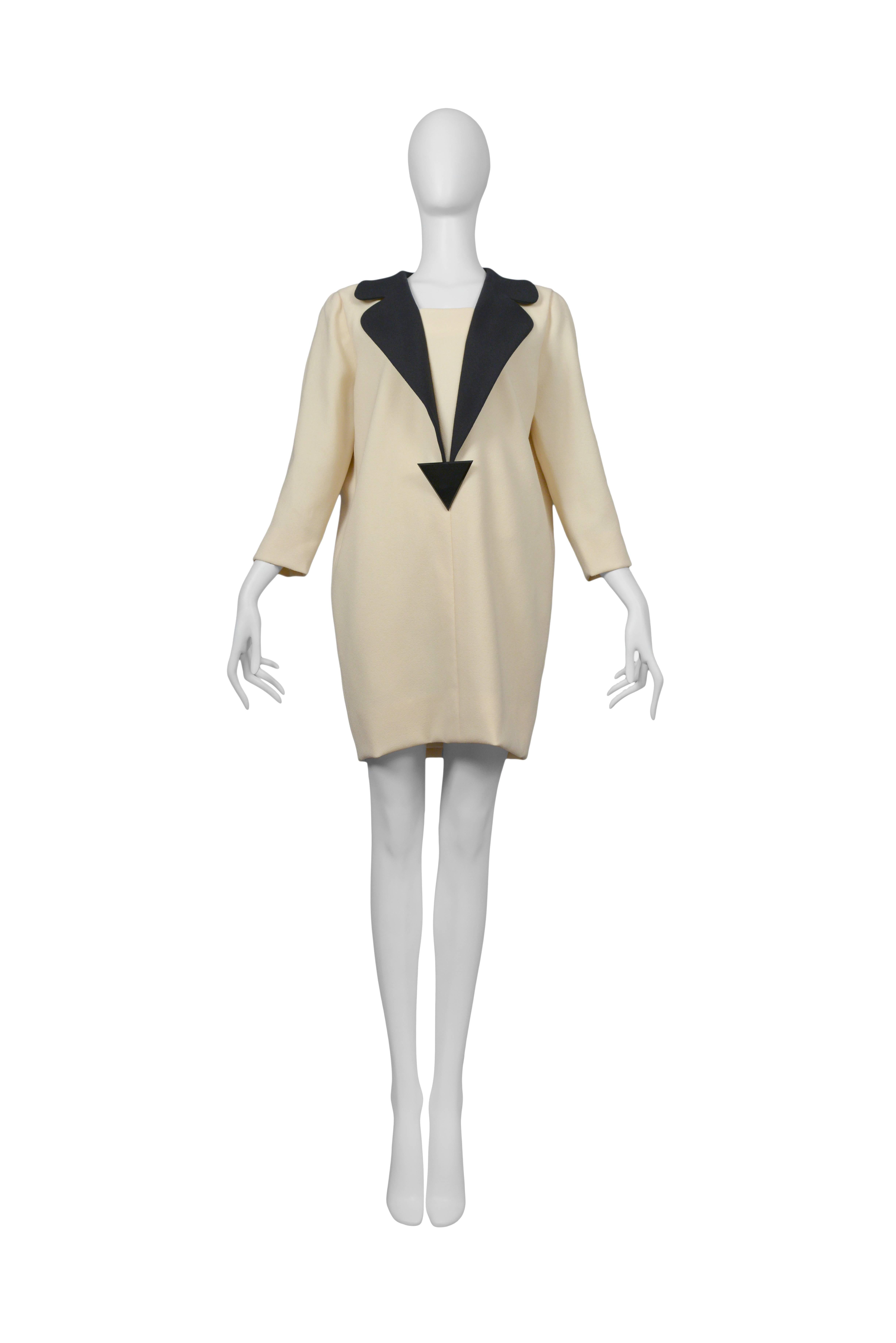 Pierre Cardin Couture smart off white dress with attached black lapels and black lucite triangle decoration. Circa, 1986 -1993.
Please inquire for additional images.