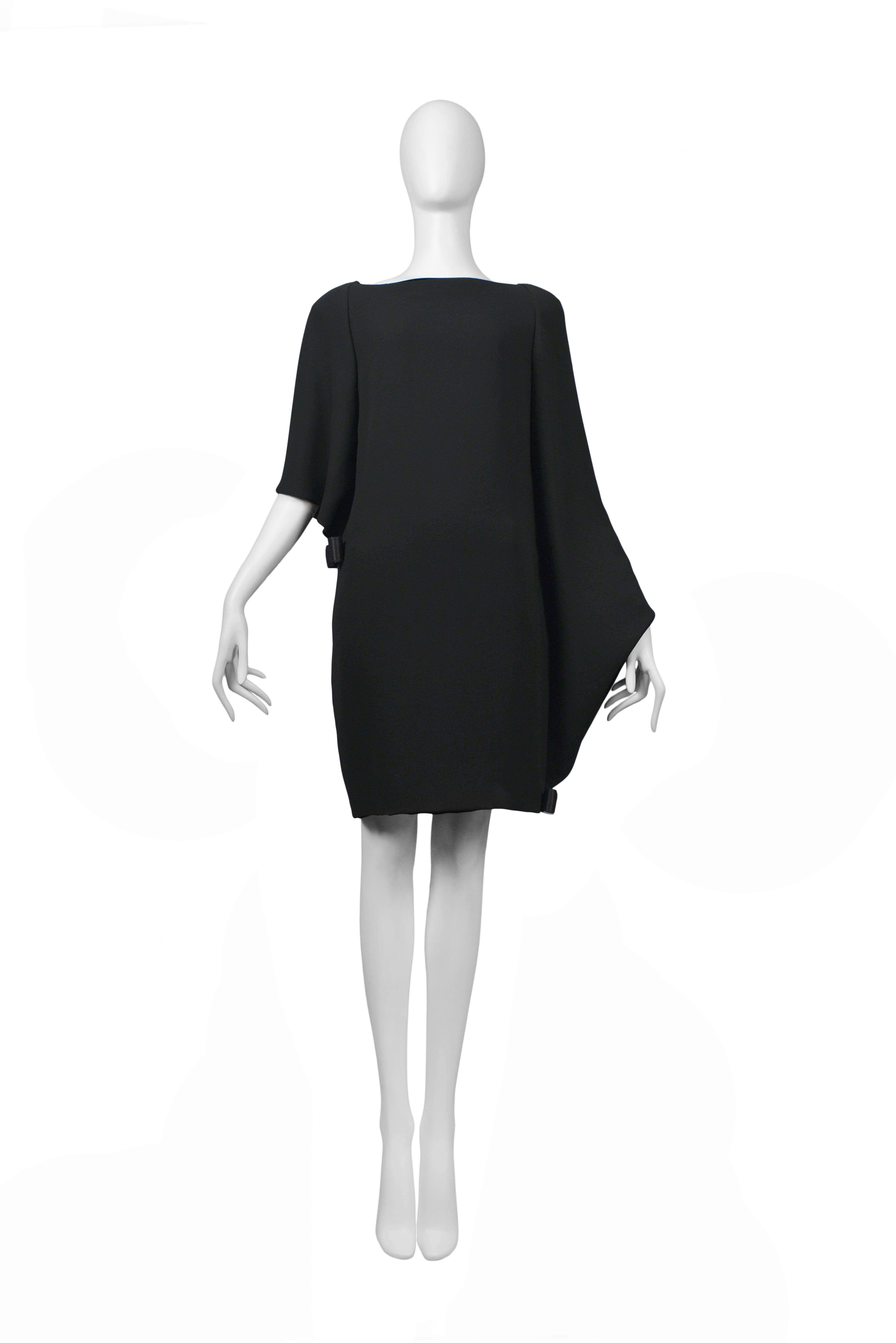 Pierre Cardin Couture black folding architectural dress with bows at hem and bust. Shawl drape back. Circa, 1986-1993.
