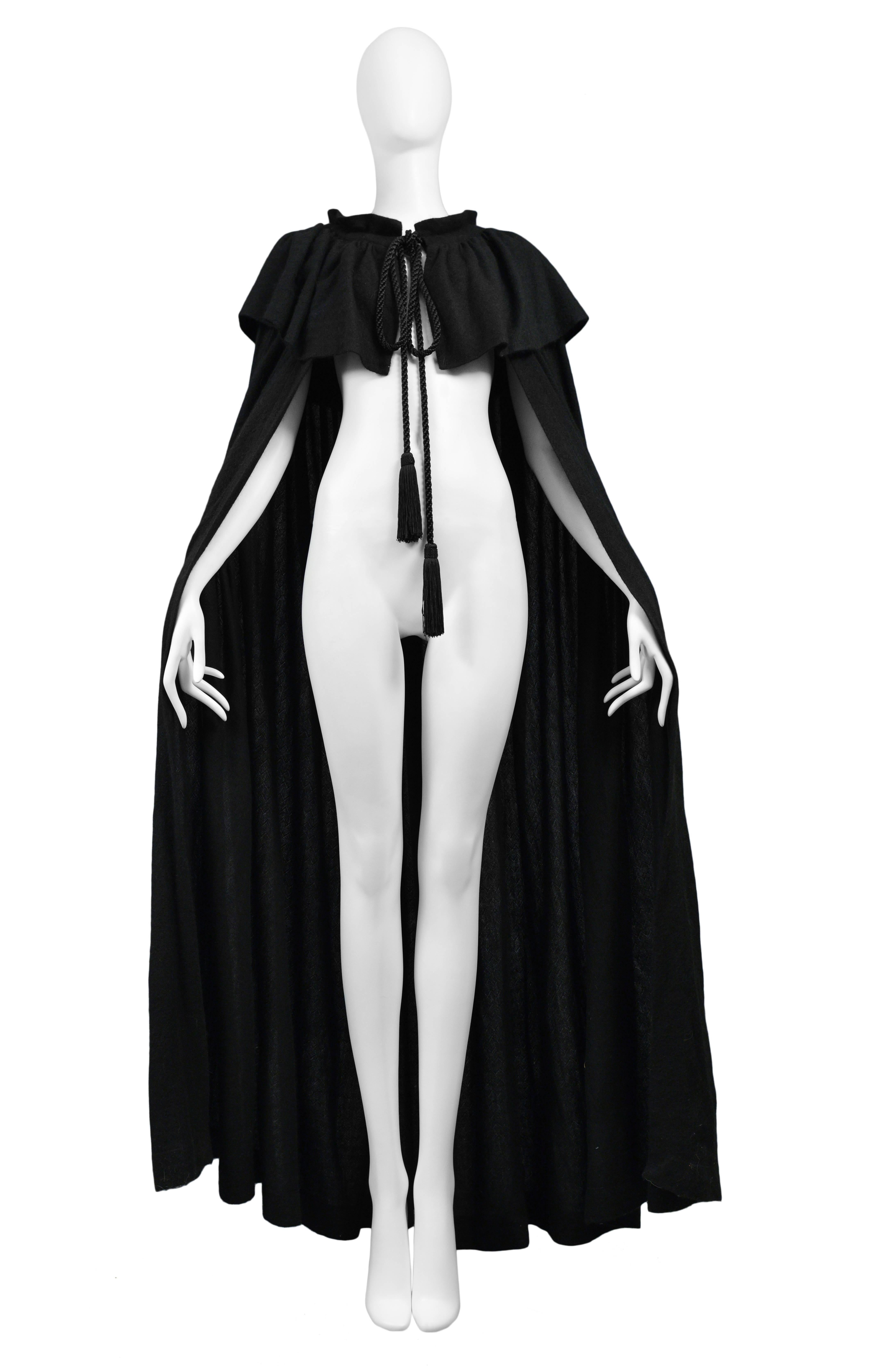 Vintage Yves Saint Laurent black cashmere collared cape with gathering around the collar and braided draw string tassels that tie at the neck. Circa 1970s.