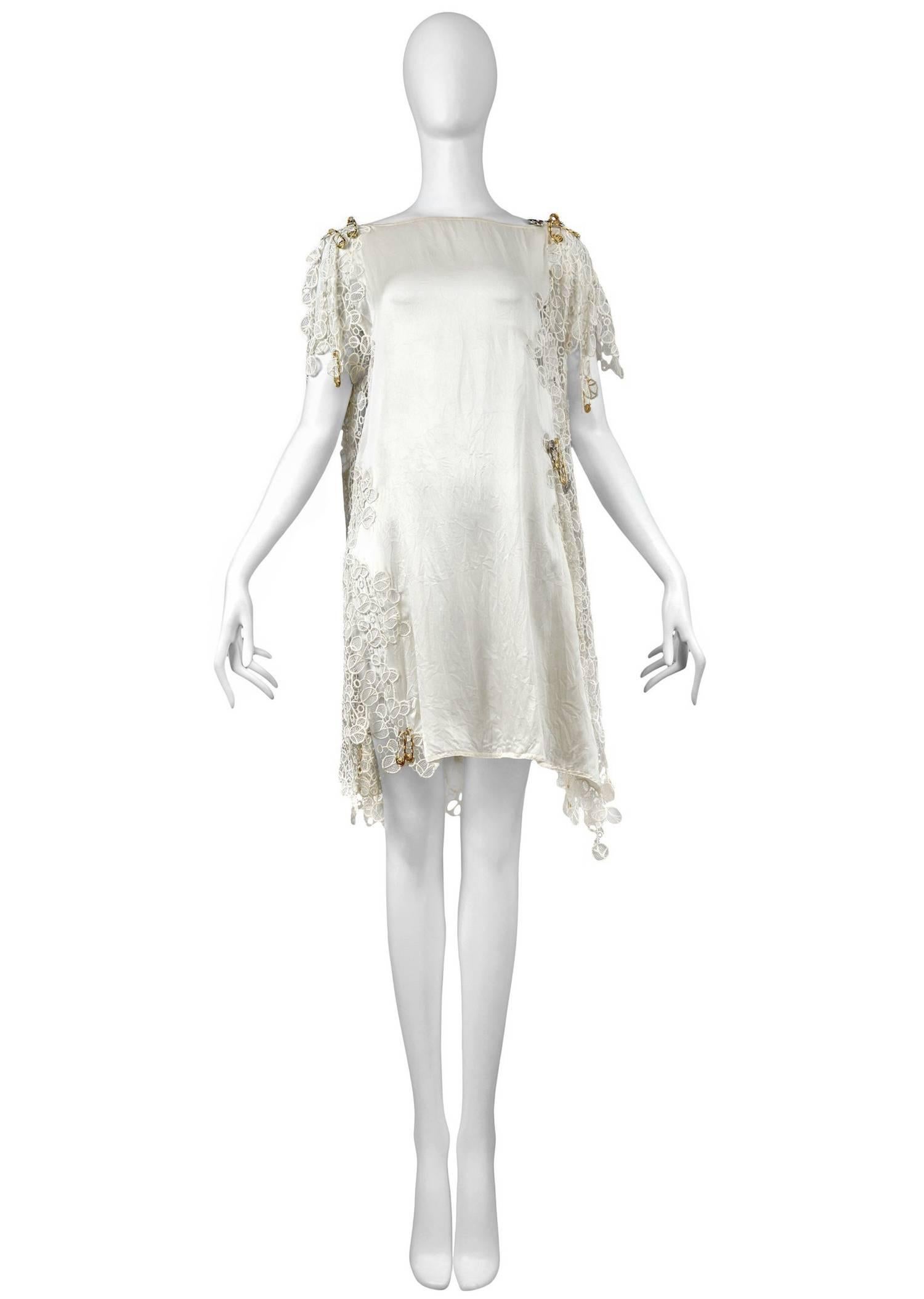 Vintage Gianni Versace trapeze style white lace dress with gold tone medusa safety pins scattered throughout the lace trim. Important design from Versace's groundbreaking and iconic 1994 collection.
Please inquire for additional images.
