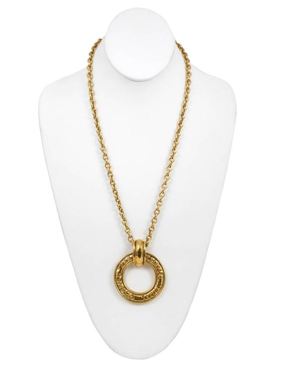 Vintage Chanel gold necklace chain with attached Chanel logo ring.
Please inquire for additional images.