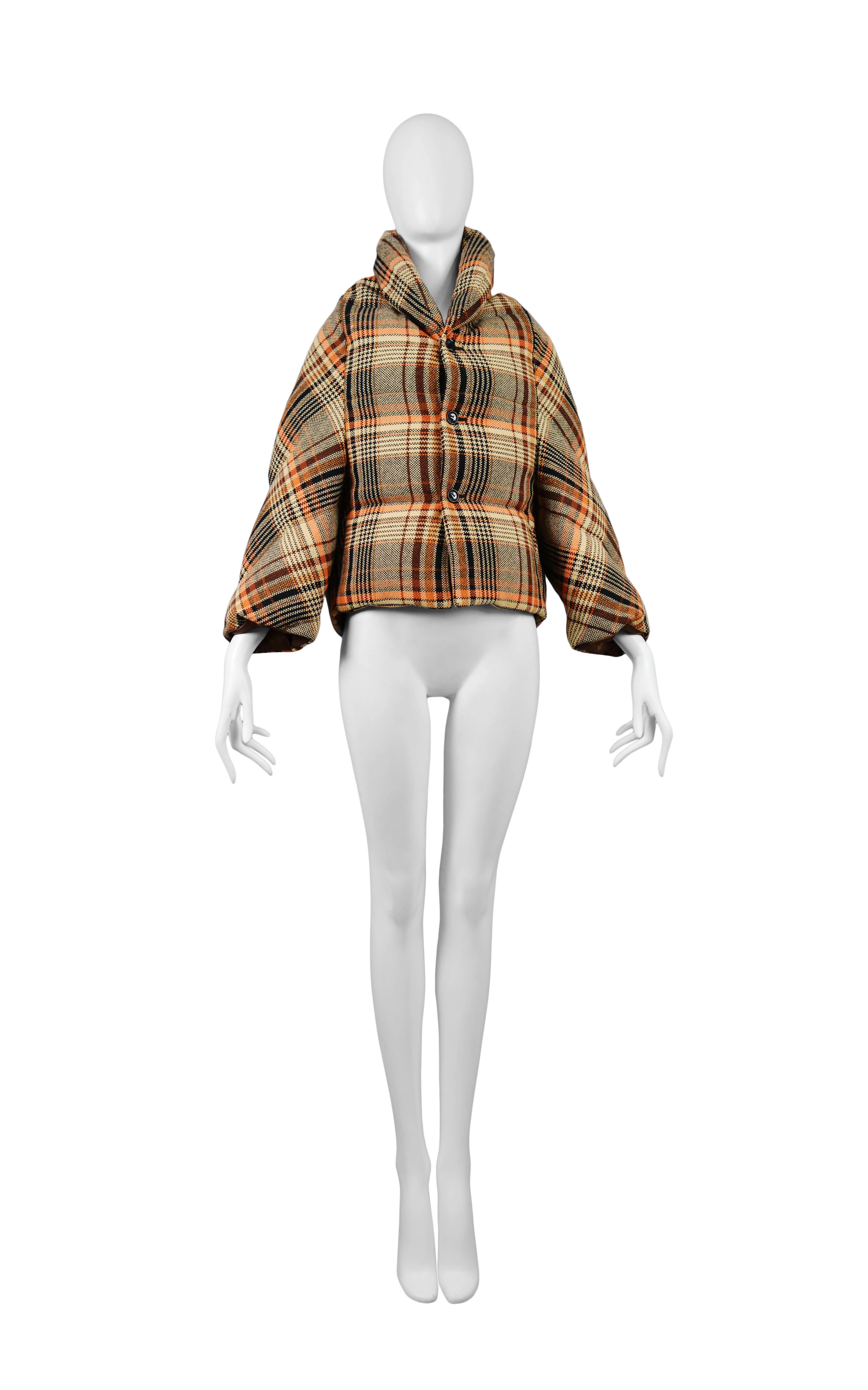 Vintage Junya Watanabe brown plaid puffer jacket featuring down stuffing and a button front closure. Circa 2004.
Please inquire for additional images.