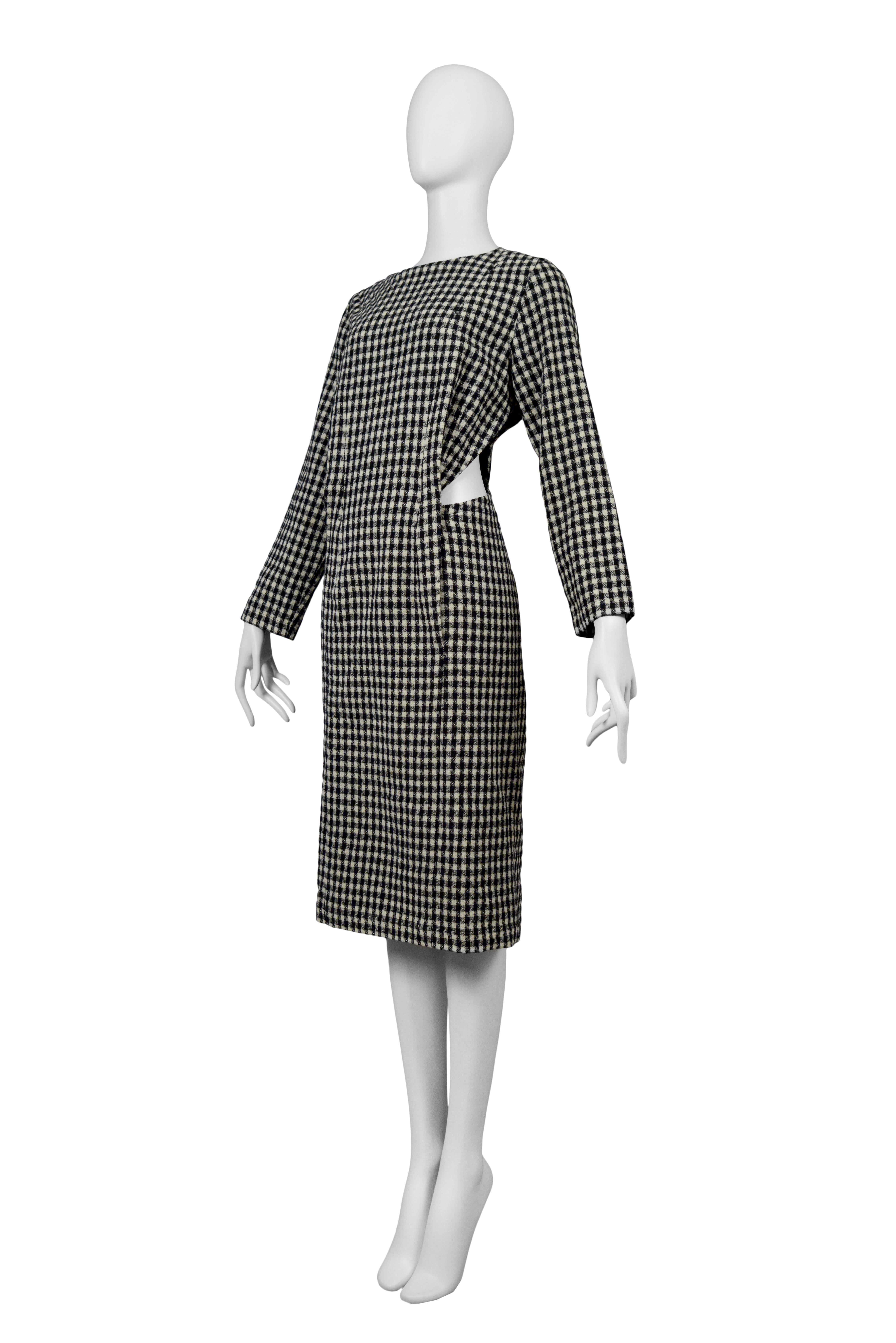 Vintage Comme des Garcons long sleeve houndstooth print dress featuring cut outs at either side of the waist. Circa 1986.
Please inquire for additional images.