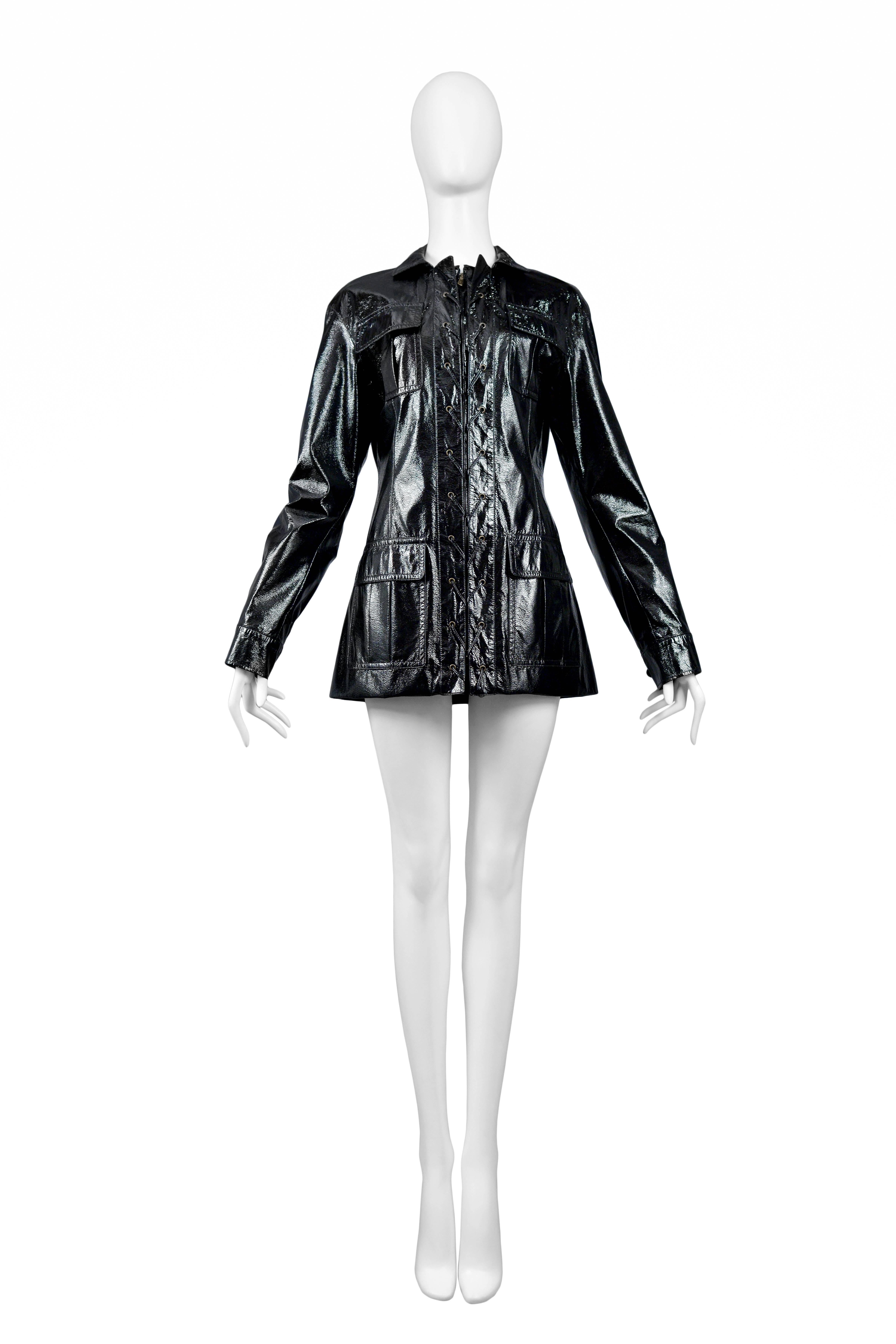 Vintage Stefano Pilati for Yves Saint Laurent black patent leather safari jacket featuring pockets at the chest and hips, a zip front closure and lace up detailing up the front.
Please inquire for additional images.