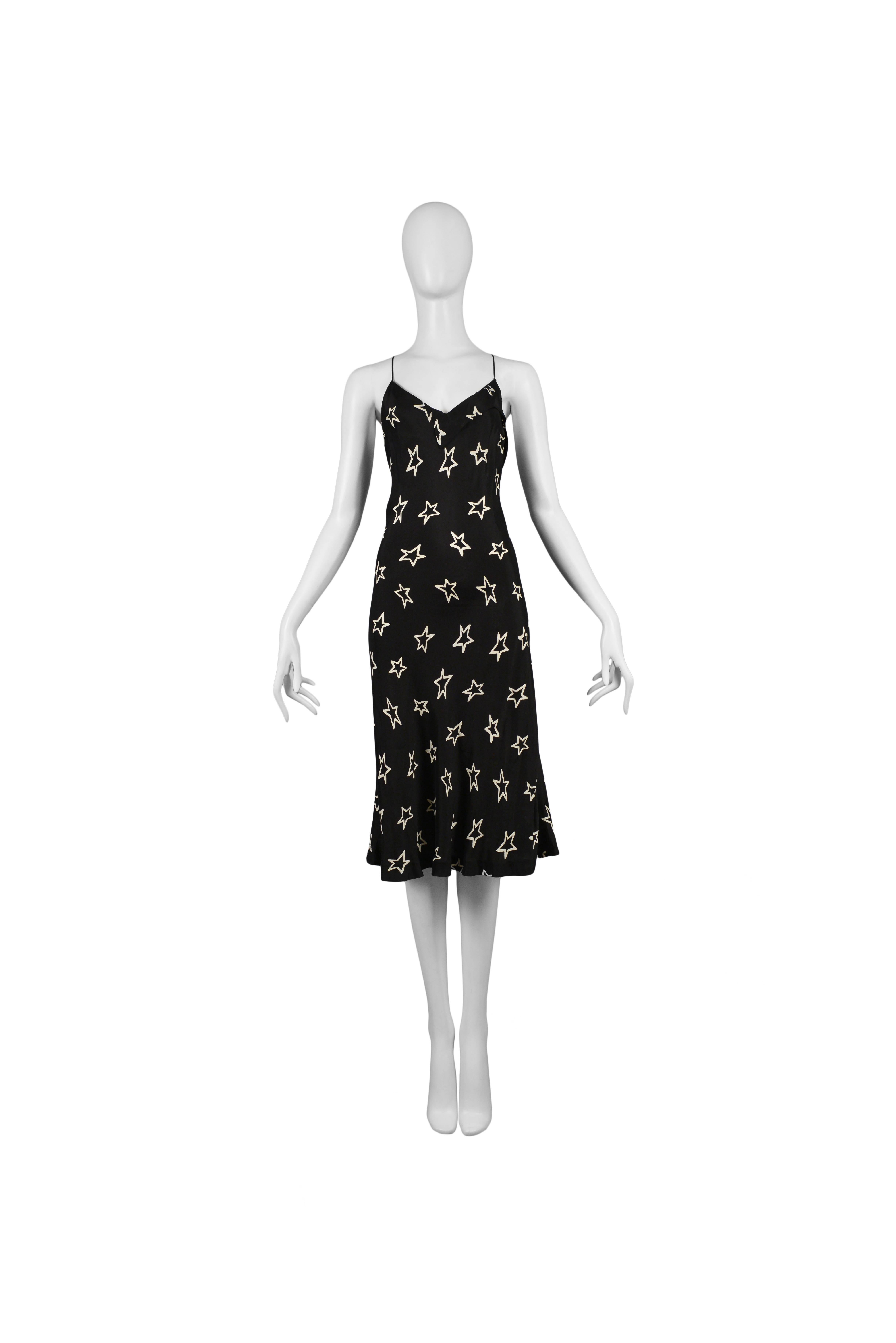 Vintage Maison Martin Margiela black slip dress featuring a v-neckline and an allover white star pattern. Circa Spring / Summer 2007.
Please inquire for additional images.
