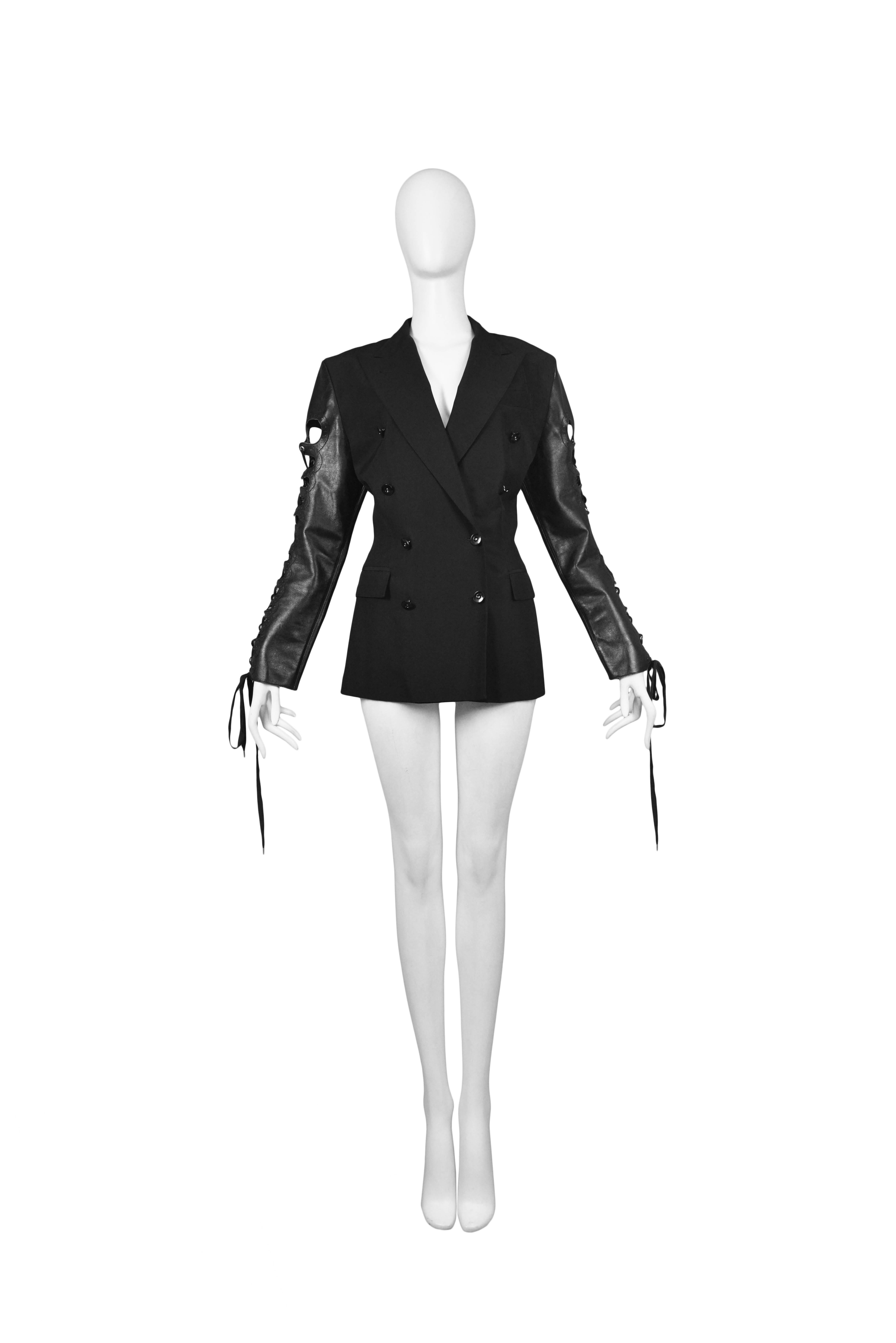 Vintage Jean Paul Gaultier black double breasted jacket featuring black leather sleeves that lace up both arms.
Please inquire for additional images.