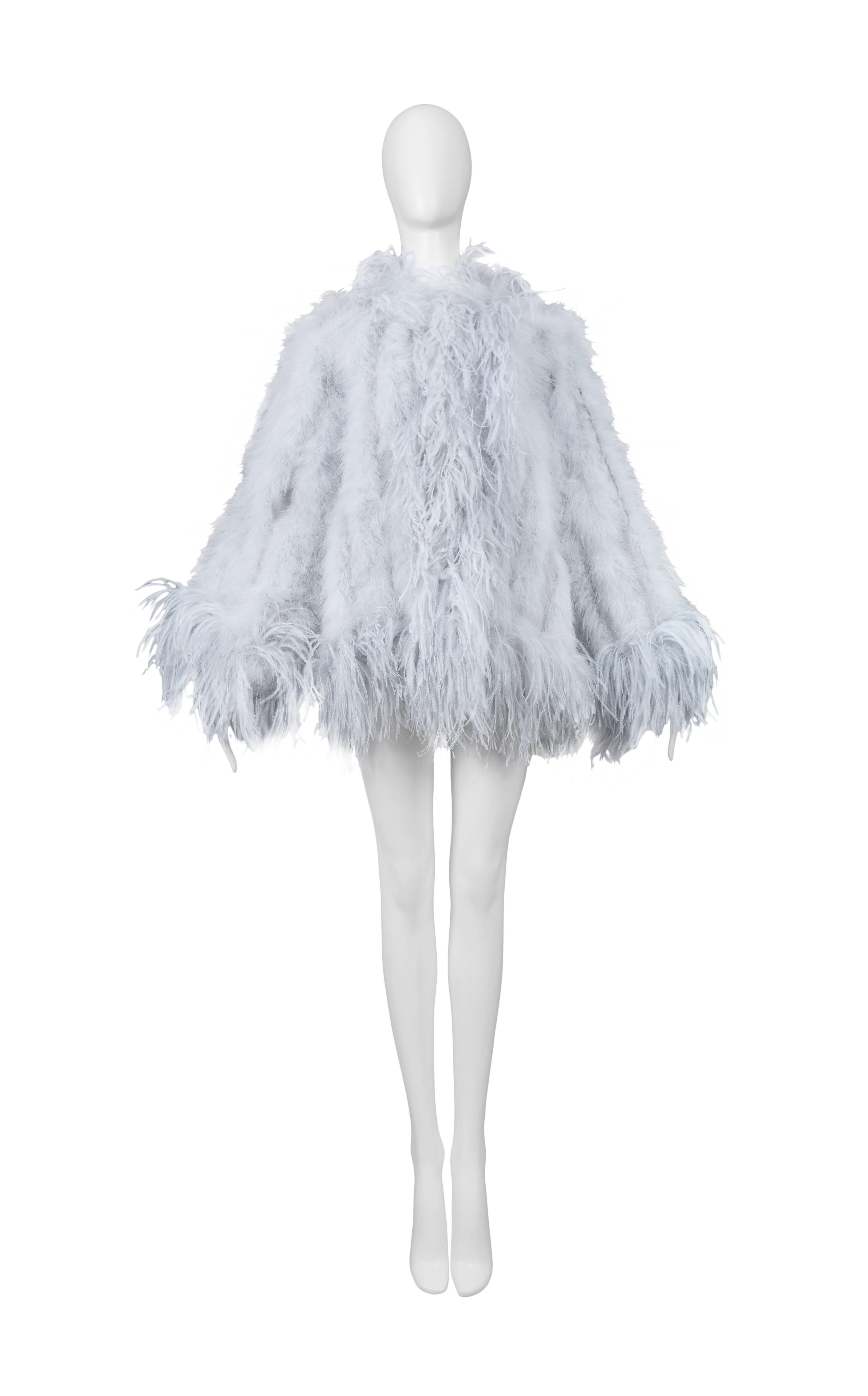 Vintage Yves Saint Laurent silver grey marabou feather coat featuring a loose feather trim along the edges.
Please inquire for additional images.