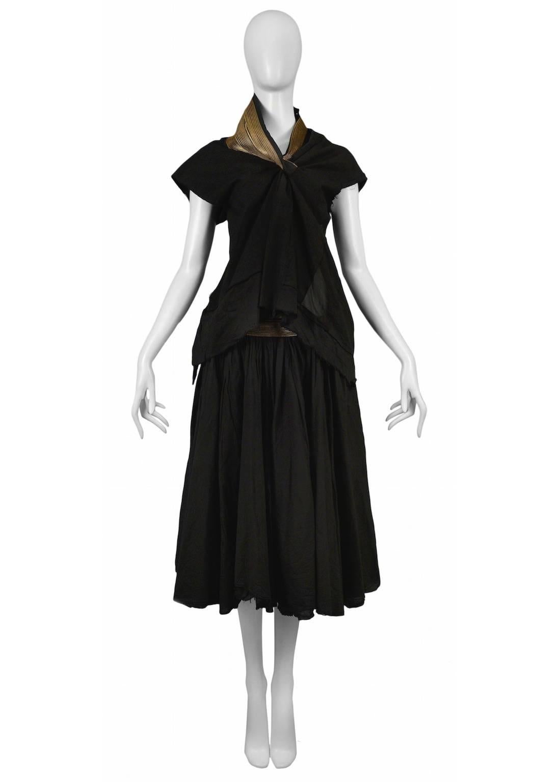 Resurrection Vintage is excited to offer a vintage Junya Watanabe for Comme des Garcons black cotton top and skirt with zipper details. The top features a high neck with zipper inset, cap sleeves, and open back. The skirt is low waisted and has a