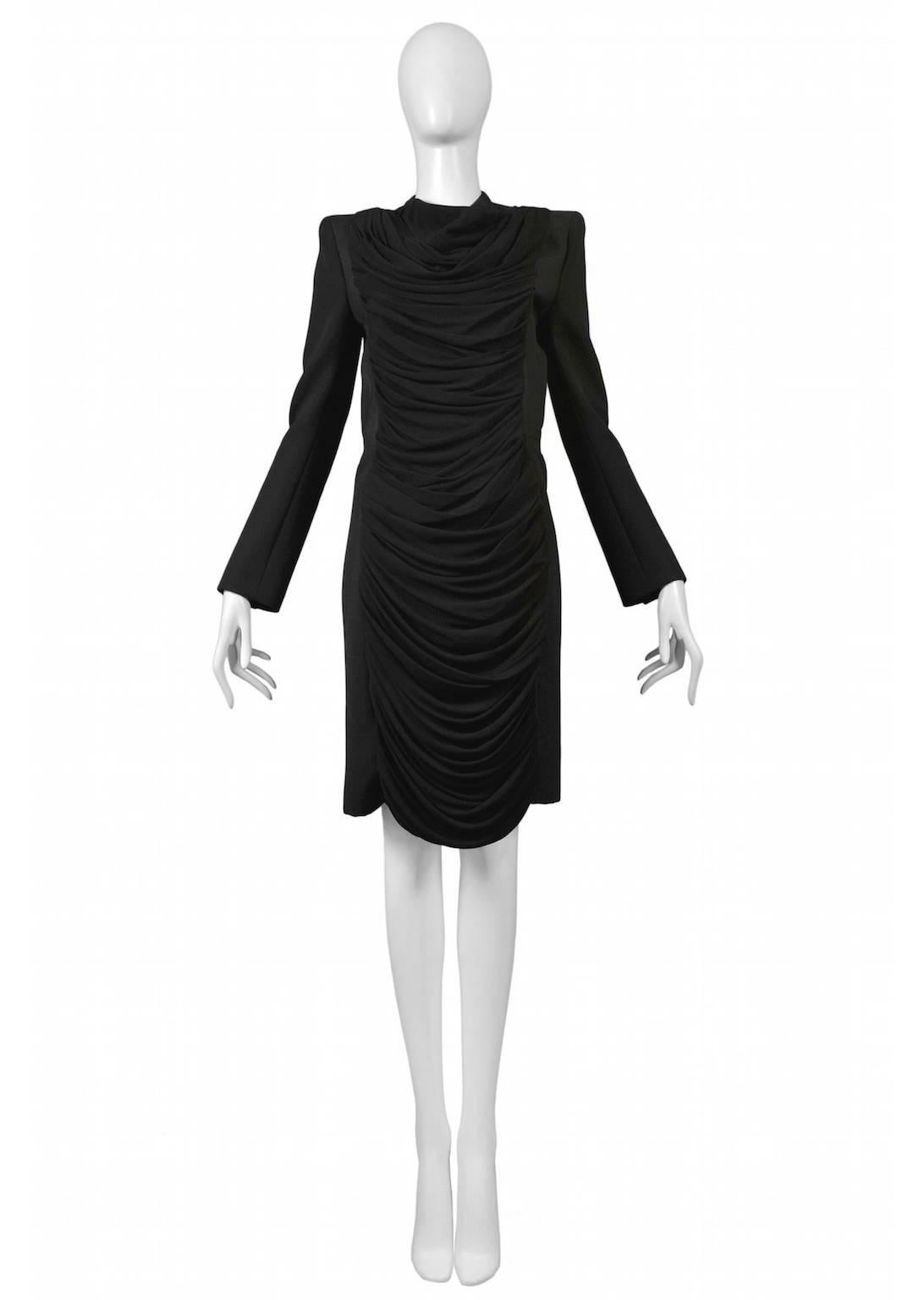 Resurrection Vintage is excited to offer a vintage Nicolas Ghesquière for Balenciaga black tailored coat-dress featuring long sleeves, a knee-length snap front panel, and asymmetrical draping down the center front panel.
Balenciaga Paris
Designed by