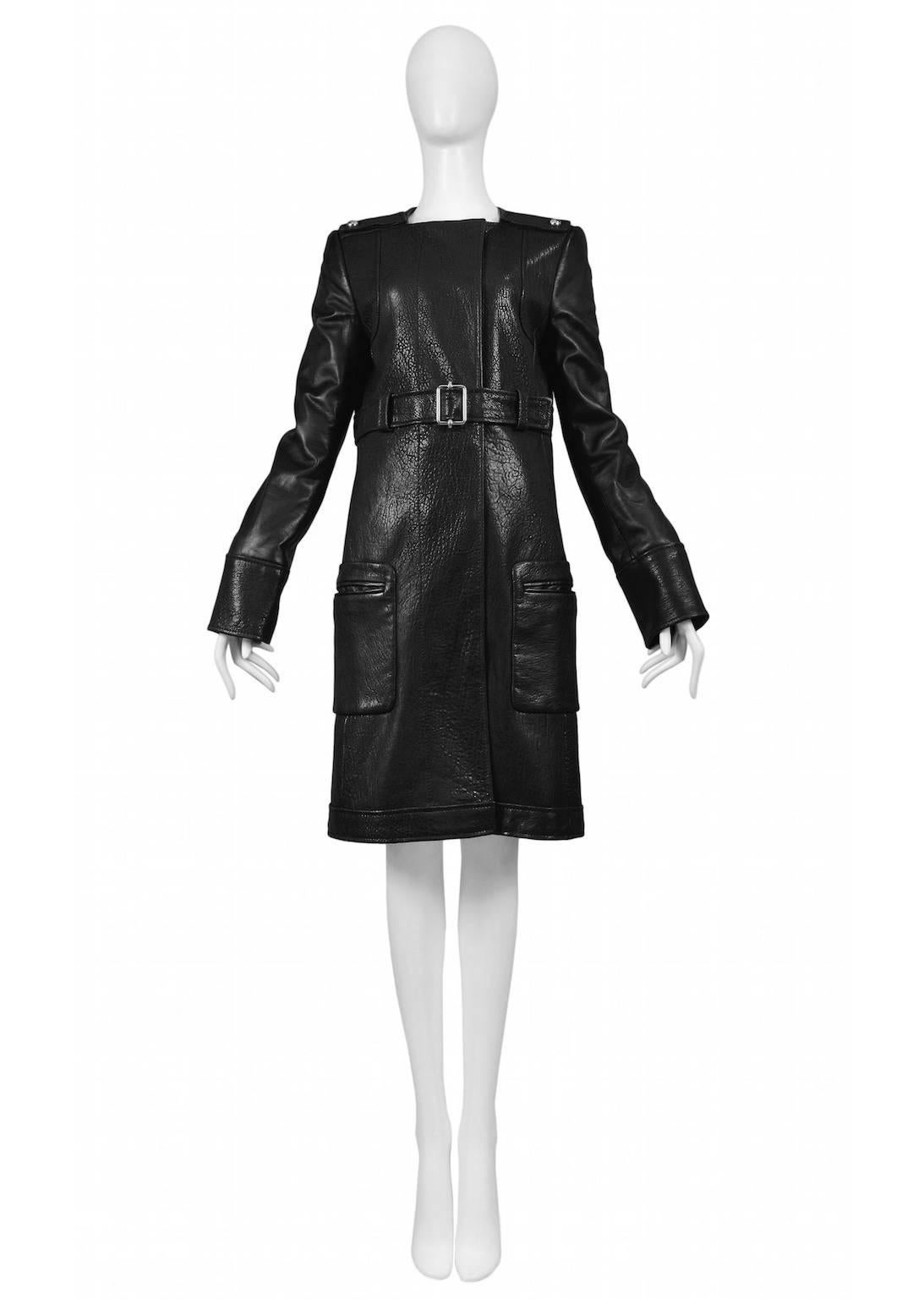 Vintage Nicolas Ghesquière for Balenciaga black leather mid length coat featuring a high waisted buckled belt and two pockets at either hip. A runway piece from the Autumn / Winter 2005 Collection.