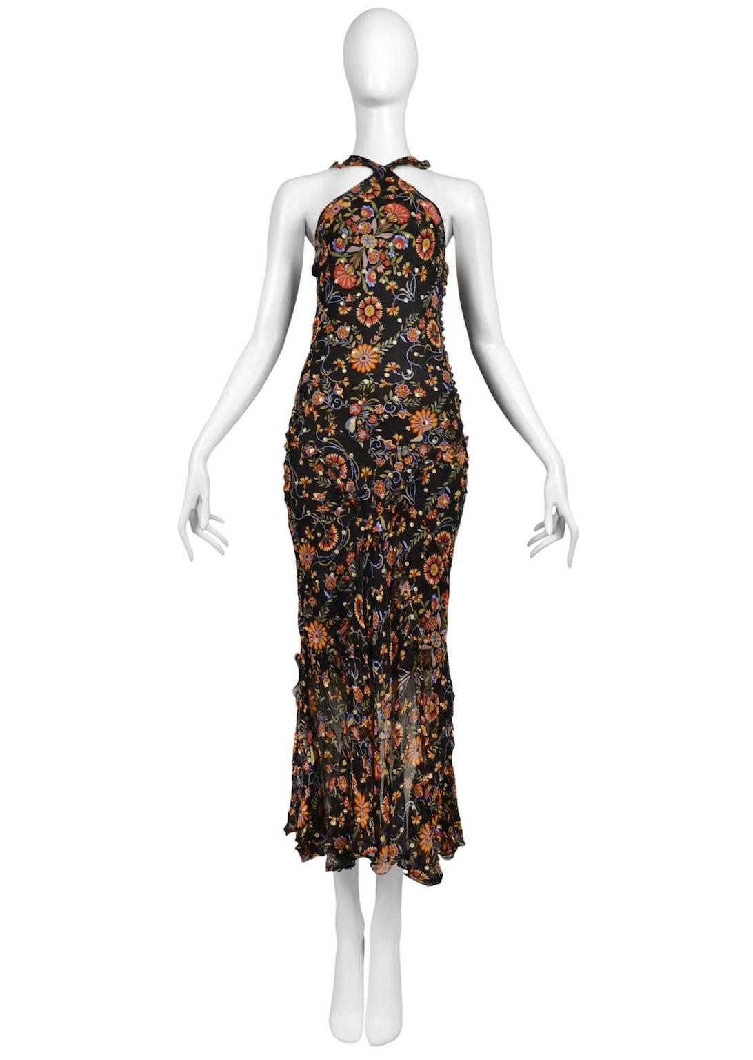 Vintage John Galliano for Christian Dior black dress featuring a side covered button entrance, ruffle detailing at the neckline and an allover yellow, red and blue floral print.