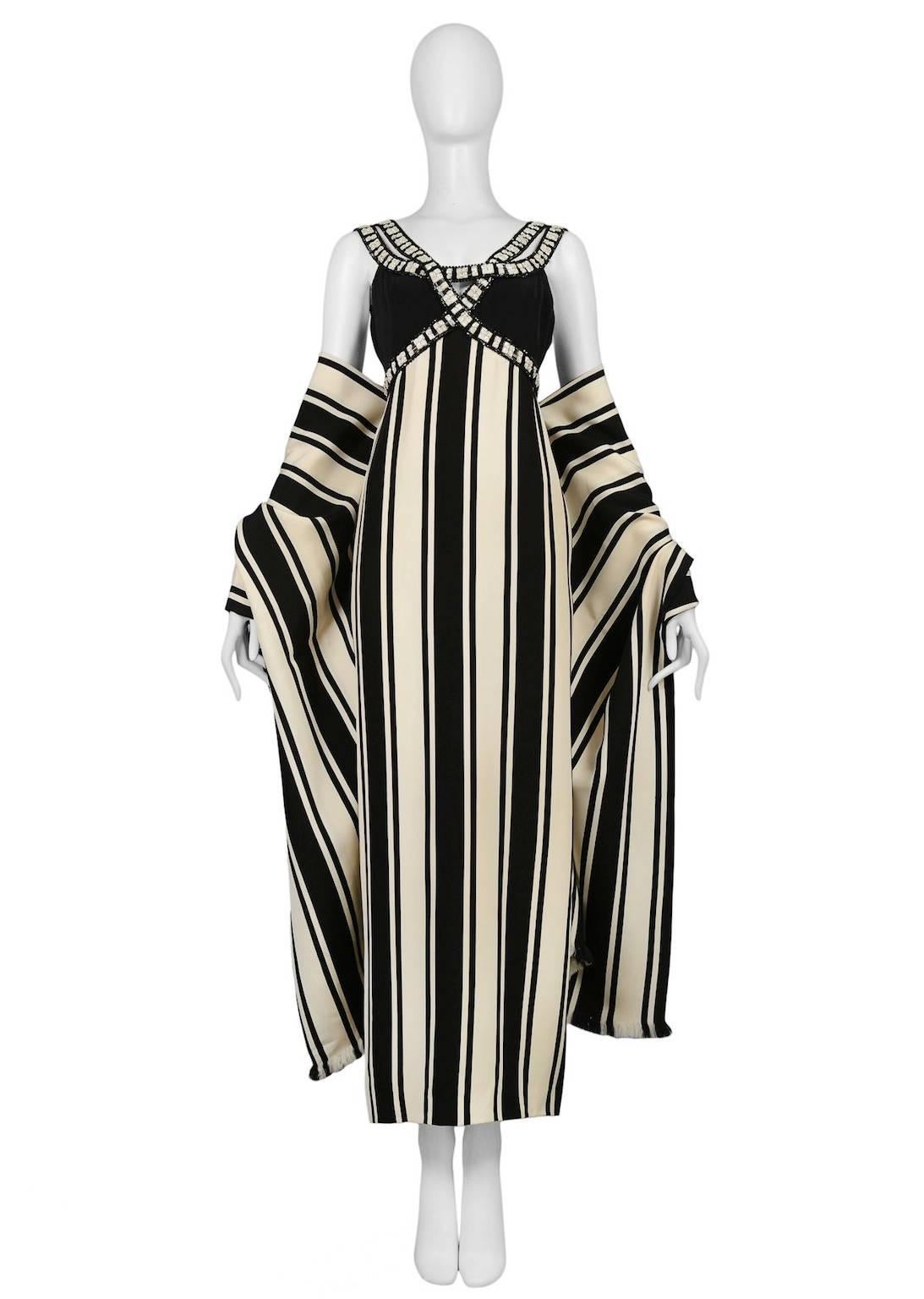 Vintage Galanos black and white silk column gown adorned with jewel and beaded overlapping front detail and double straps. The gown comes with a matching stripe shawl featuring fringed trim.