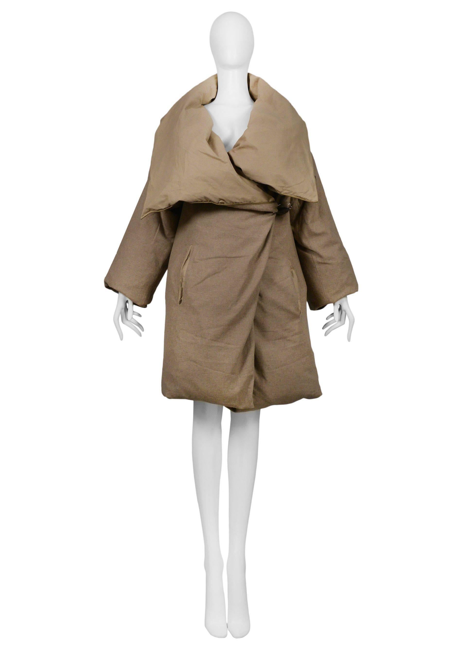 Original Maison Martin Margiela Duvet Coat made from a Featherlite 100% down filled duvet featuring a rare olive colored Duvet Coat cover with leather wrapped safety pin closure. Coat can be worn without cover which looks identical to Off White