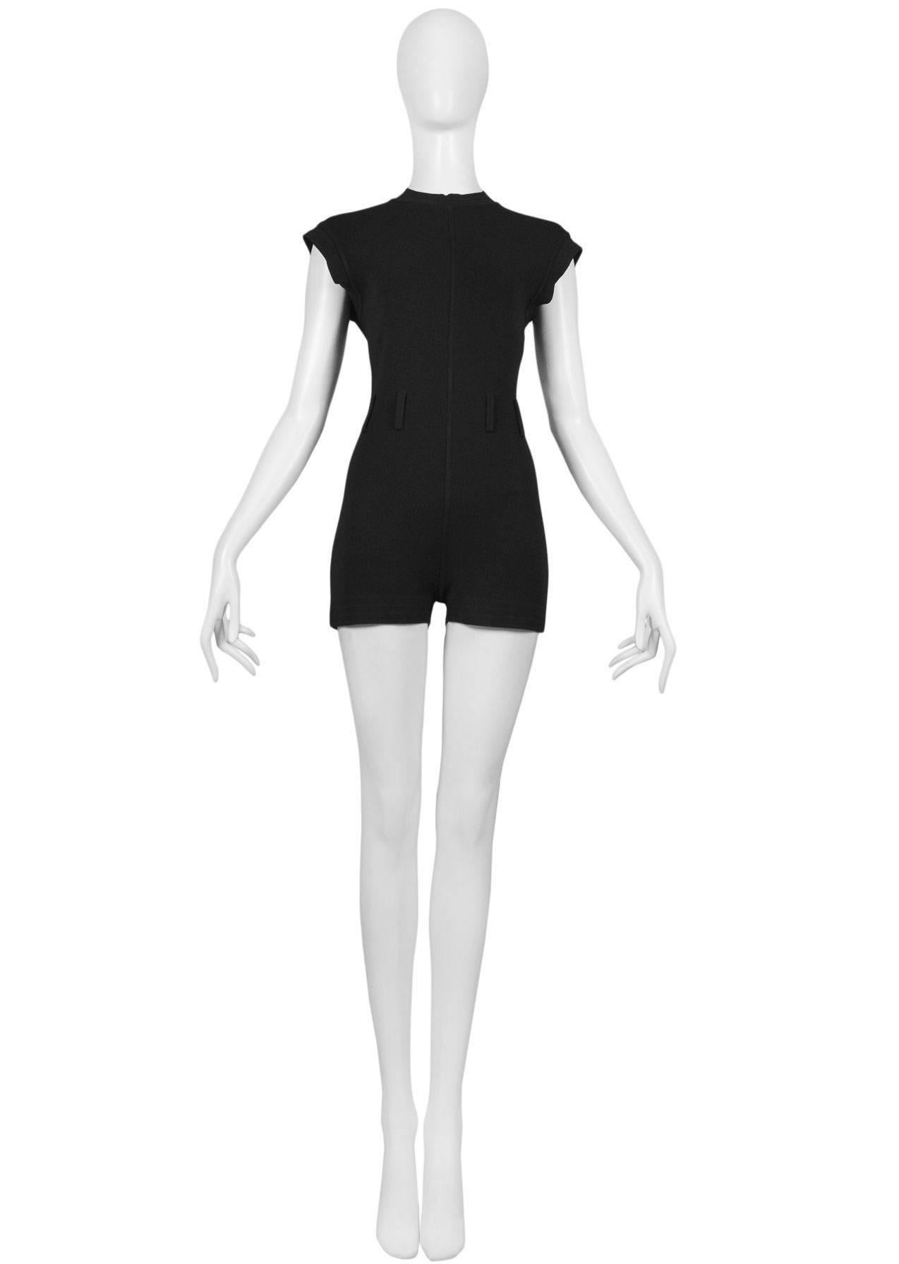 Vintage Azzedine Alaia black knit mini shorts romper. This piece features graphic seaming lines and cuff details, zipper at back, and belt loops at the waist. Fitted body with strong stretch. Iconic 1990's silhouette. 