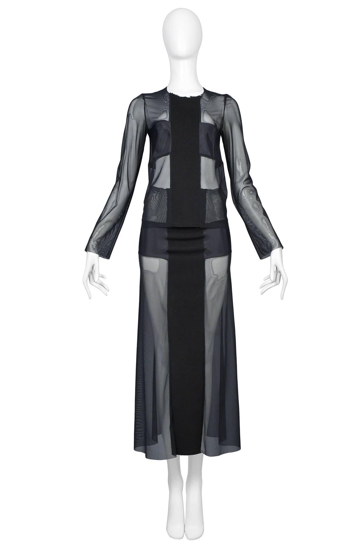 Resurrection Vintage is excited to offer a vintage Comme des Garcons mesh ensemble featuring a top with a center front black cross, high neck, raw edges, and long sleeves. The skirt features a soft waistband, a front contrasting panel, and ankle