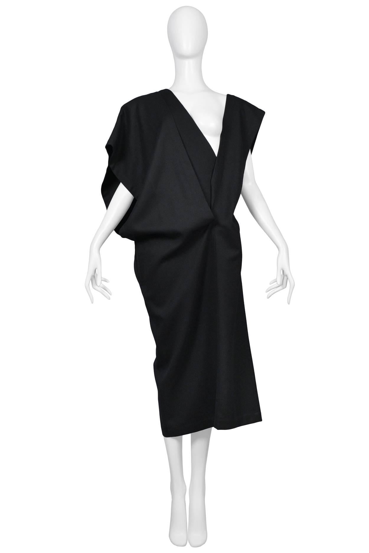 Early and rare Comme des Garcons black jersey dress with three V bands that can be work various ways. Dress features straight skirt. Circa 1980's/