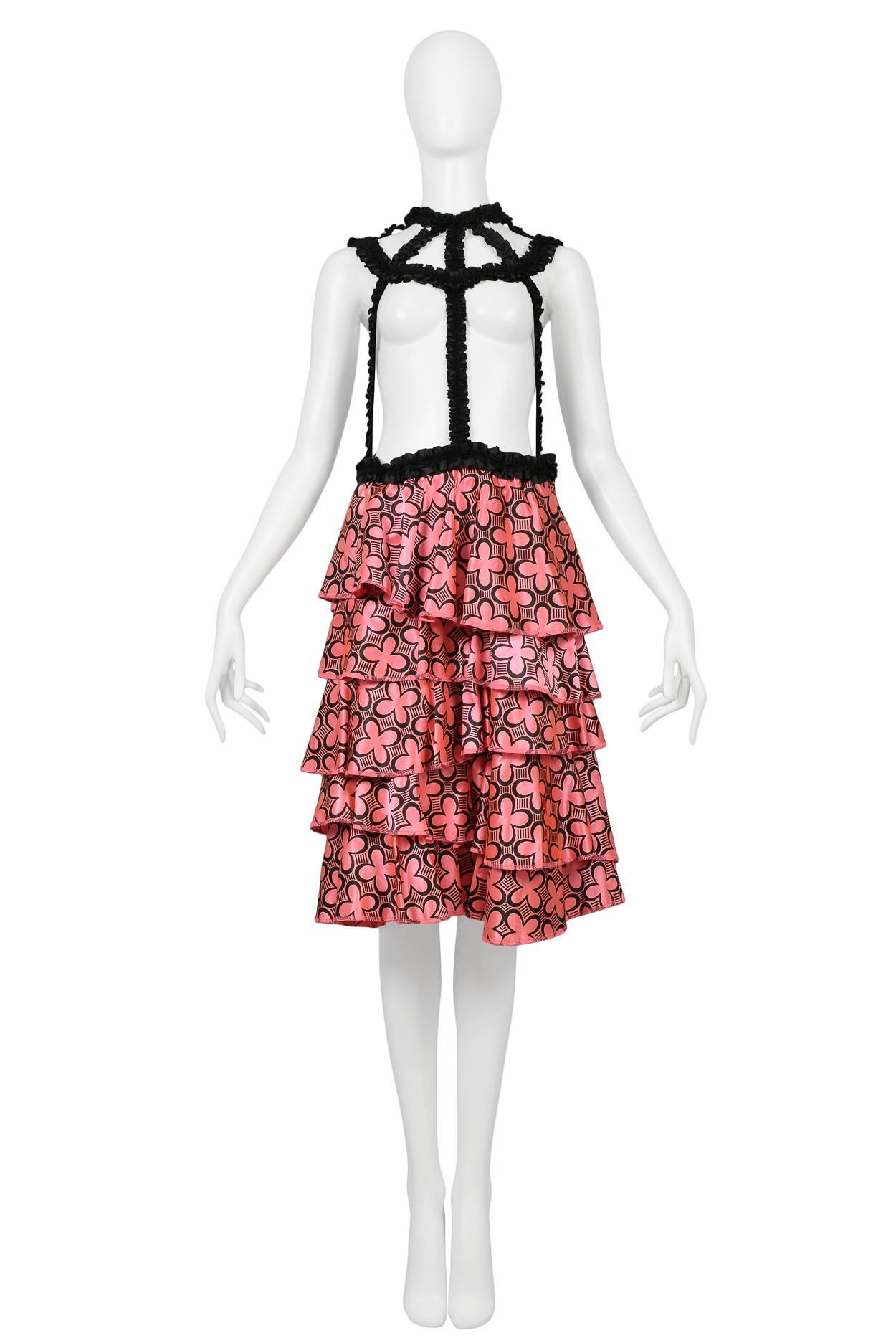 Comme des Garcons black satin ruffle braces dress with pink satin printed ruffle skirt. Bad Taste collection, AW 2008.