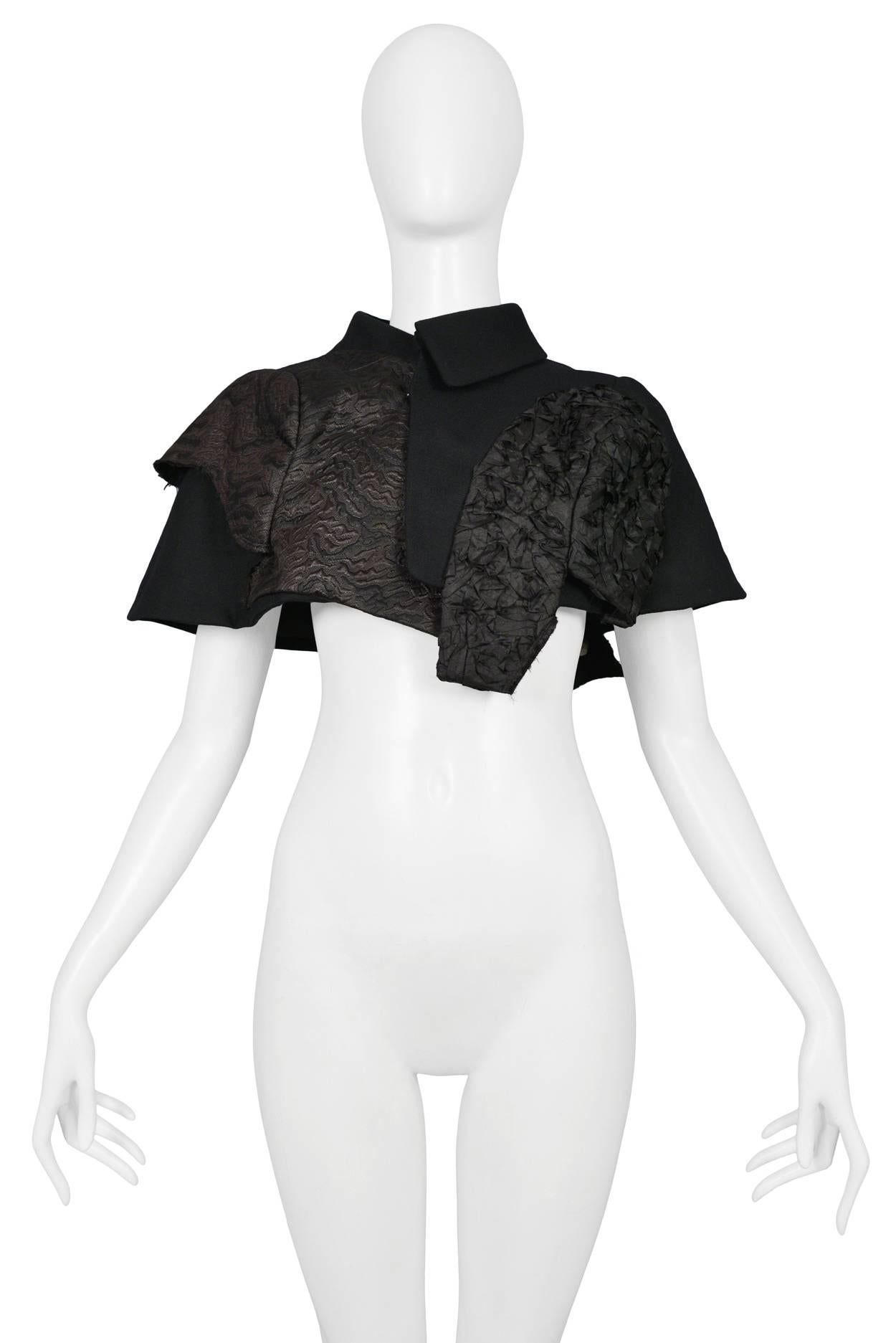 Comme des Garcons black capelet with mixed fabrics. Features sequin and velvet fabric insets. SS 2010.