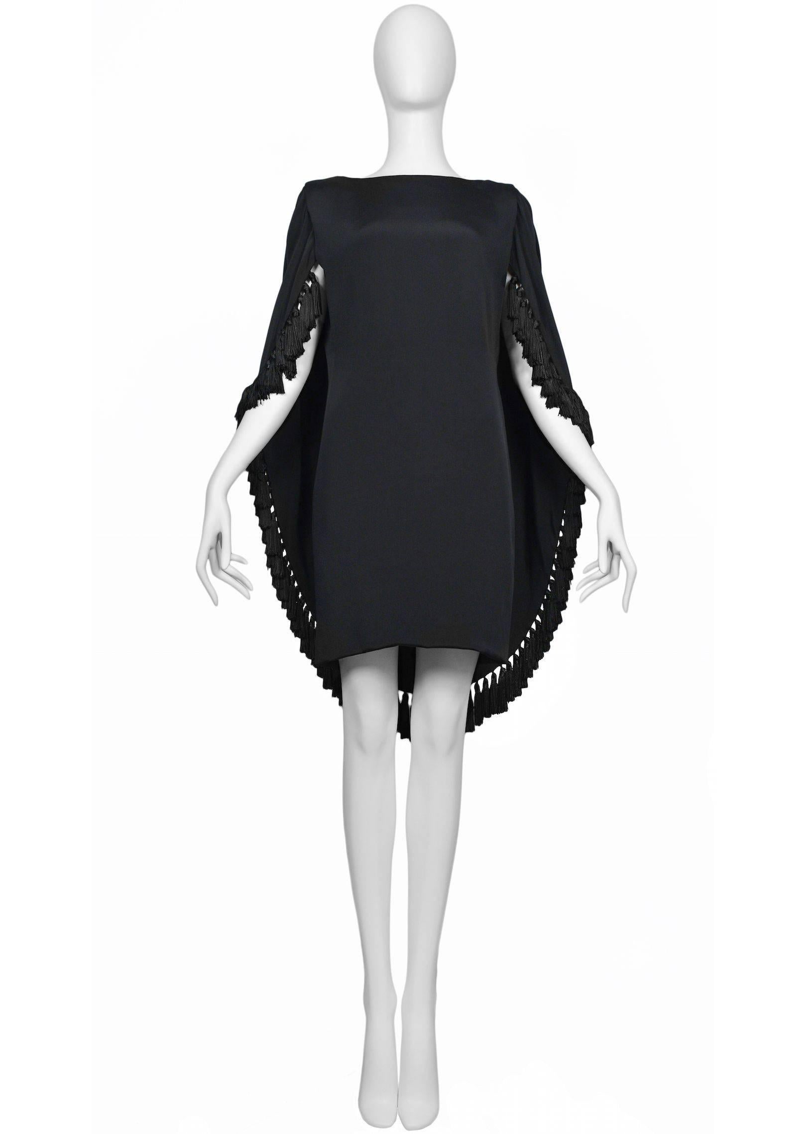 Pierre Cardin Couture black silk cape dress with tassel fringe trim and open drape back. Circa, 1986 -1993.