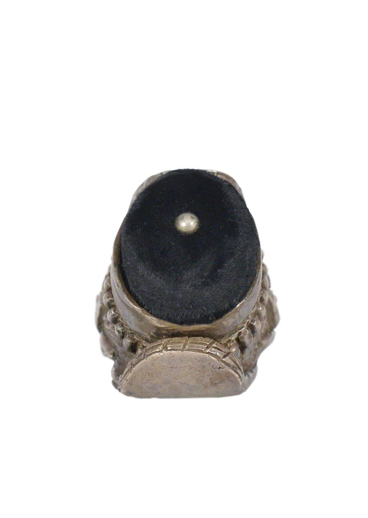 Tom Ford for Yves Saint Laurent oversized cast metal ring with black velvet cushion cabochon and silver tone bead at center. Massive ring features chunky detailing and engraving. Featured on the runway and in advertising AW 2002. 