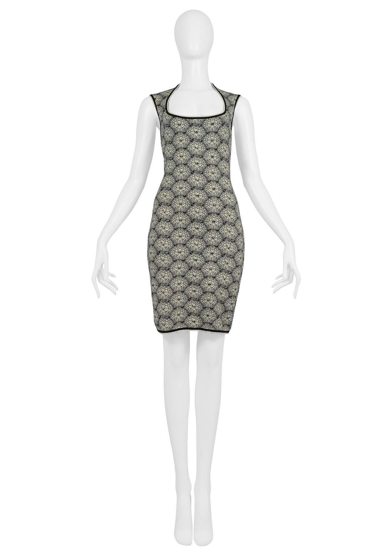 Vintage Azzedine Alaia off-white and black knit bodycon dress with "Spider Web" motiff. The dress has a deep round neckline that features black trim and off white scallop trim. Sleeves and hem feature same black and white trims. Zipper at