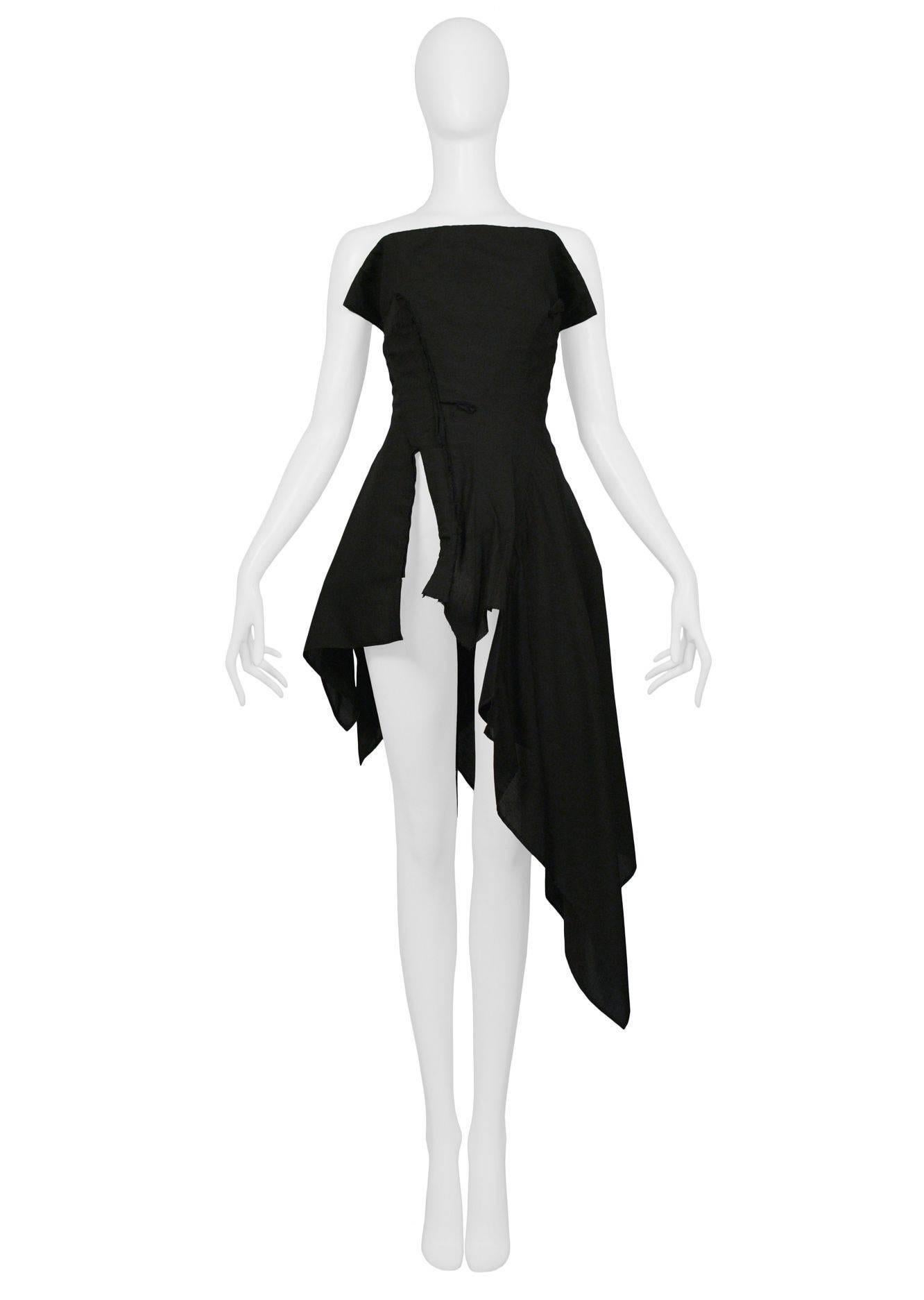 Yohji Yamamoto black strapless fitted corset top with asymmetrical skirt and hem. Slit at front.