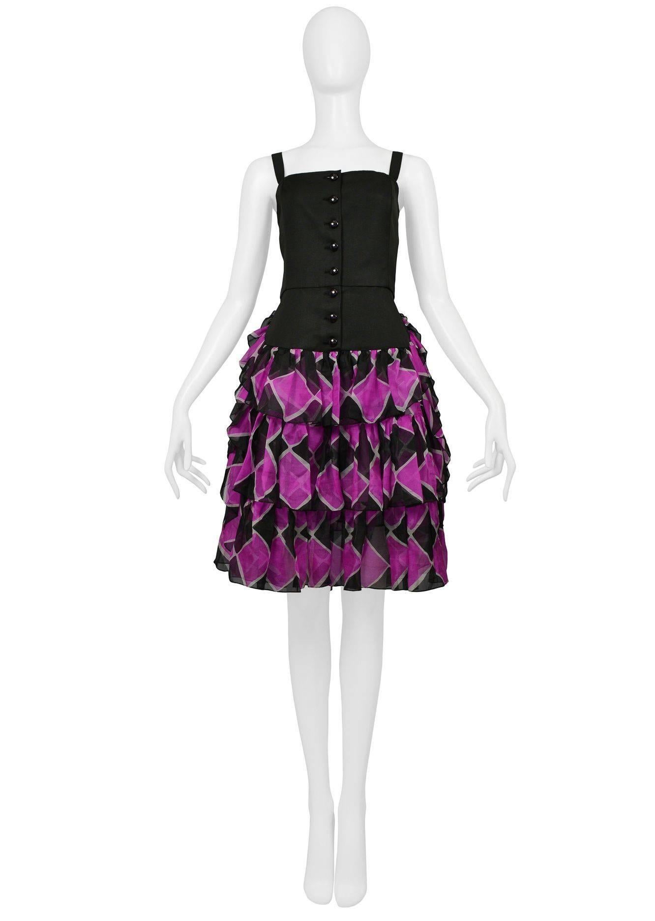 Vintage Yves Saint Laurent cotton black and magenta dress with black bodice and harlequin print skirt. Bodice features fitted waistline and button up front. Skirt features three ruffled tiers.